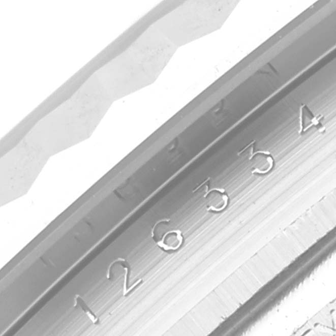 The image shows a close-up of the Rolex Datejust 41 126334 Men's Stainless Steel Blue Dial model's engraved inner bezel and fluted outer bezel.