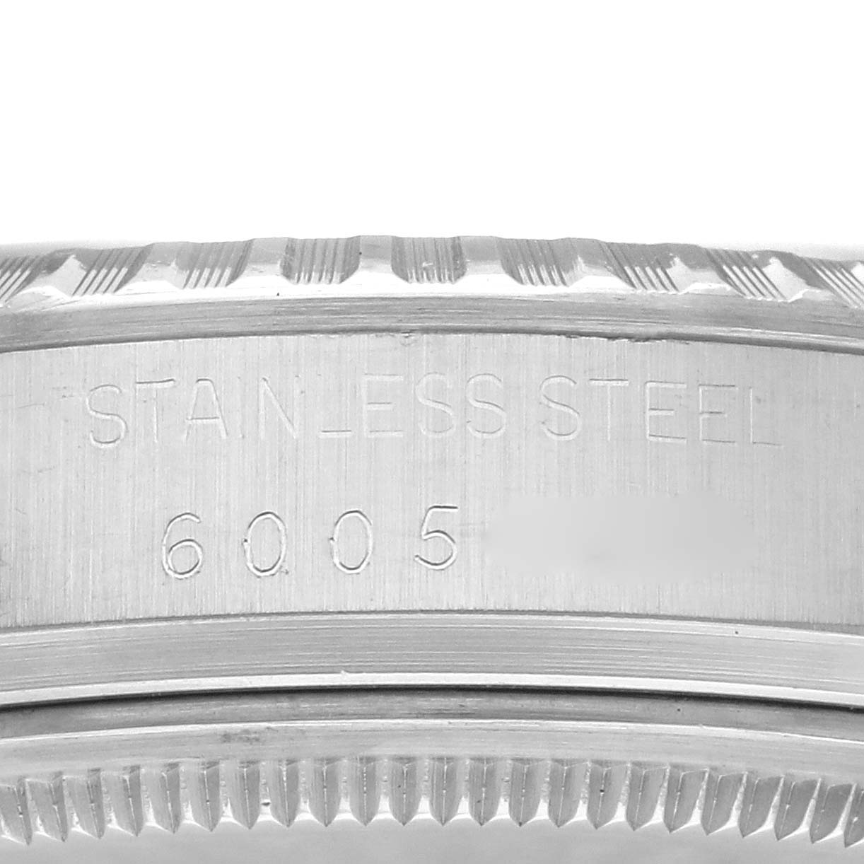 The image shows a close-up of the side of the bezel and case back of a Rolex Vintage Collection 16030 Men's Stainless Steel Silver Dial 16030 Men's Stainless Steel Silver Dial model, displaying "STAINLESS STEEL 6005."