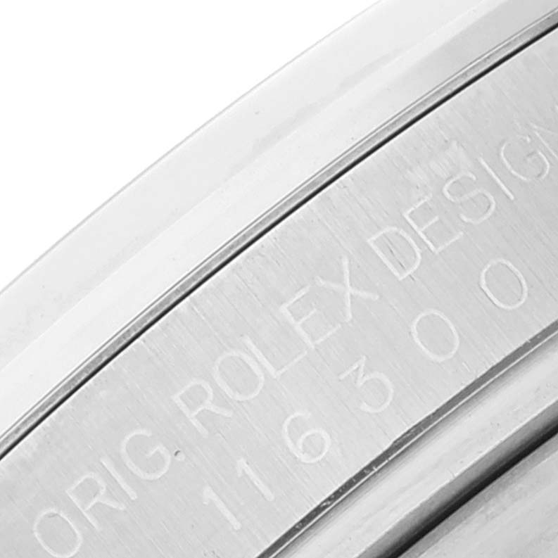 Close-up angle showing the engraved edge of the Rolex Datejust 116300 Men's Stainless Steel Blue Dial 116300 Men's Stainless Steel Blue Dial model with "ORIG. ROLEX DESIGN 116300" visible.