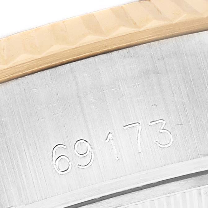 The image shows a close-up of the edge of the Rolex Datejust 69173 Women's Steel and Gold (two tone) Grey Dial 69173 Women's Steel and Gold (two tone) Grey Dial watch bezel and part of the engraved serial number.