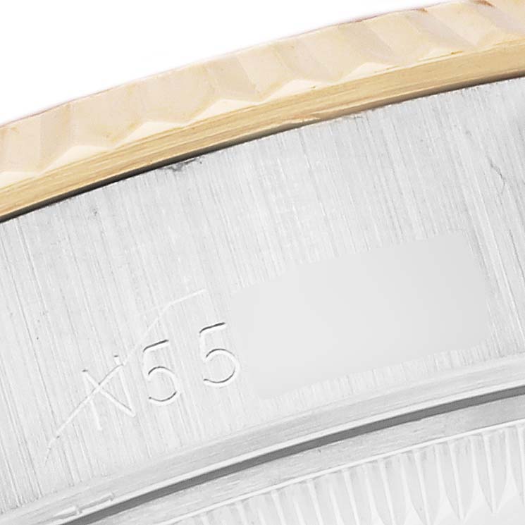 This image shows a close-up of the engraved part of the bezel and serial number on a Rolex Datejust 69173 Women's Steel and Gold (two tone) Grey Dial 69173 Women's Steel and Gold (two tone) Grey Dial watch.
