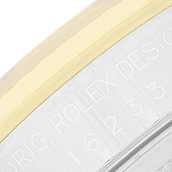 This close-up image of the Rolex Datejust 16233 Men's Steel and Gold (two tone) Black Dial 16233 Men's Steel and Gold (two tone) Black Dial model shows part of the case back and the engraved text.