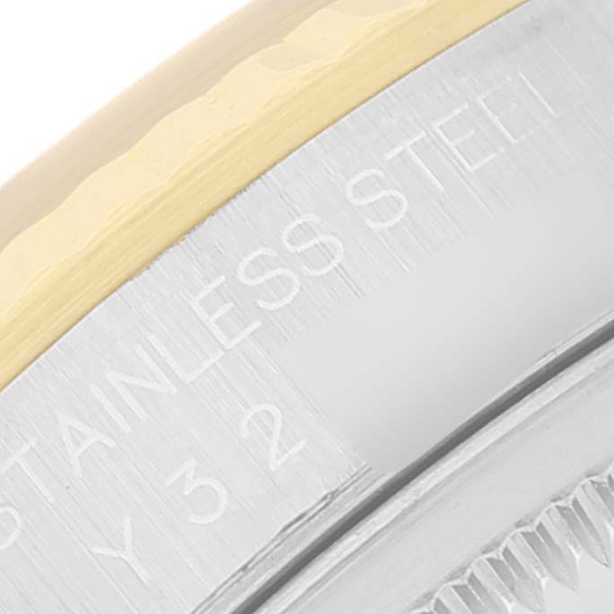 This image shows a close-up of the Rolex Datejust 16233 Men's Steel and Gold (two tone) Black Dial 16233 Men's Steel and Gold (two tone) Black Dial watch bezel and the edge of the case, featuring "STAINLESS STEEL" text.