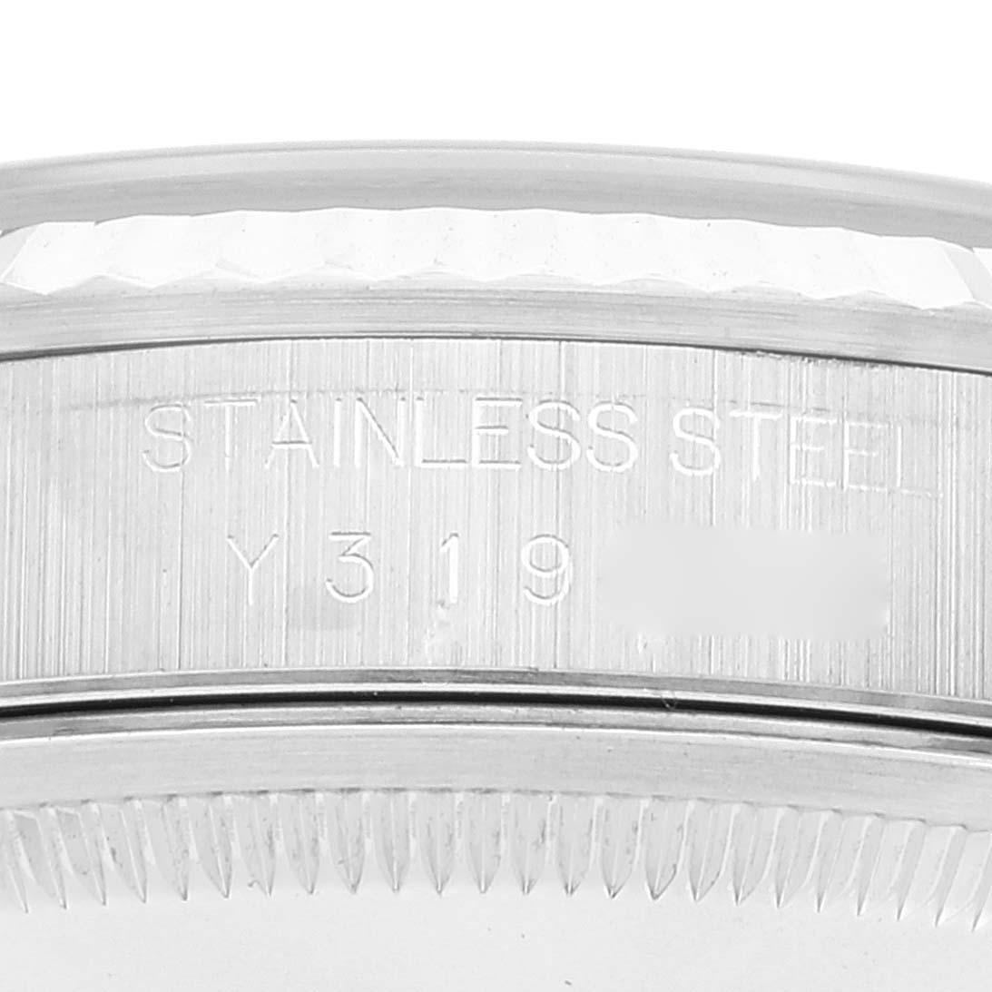 This image shows a close-up of the case side and serial number of a Rolex Datejust 16234 Men's Stainless Steel Black Dial 16234 Men's Stainless Steel Black Dial watch, highlighting "STAINLESS STEEL" engraving.