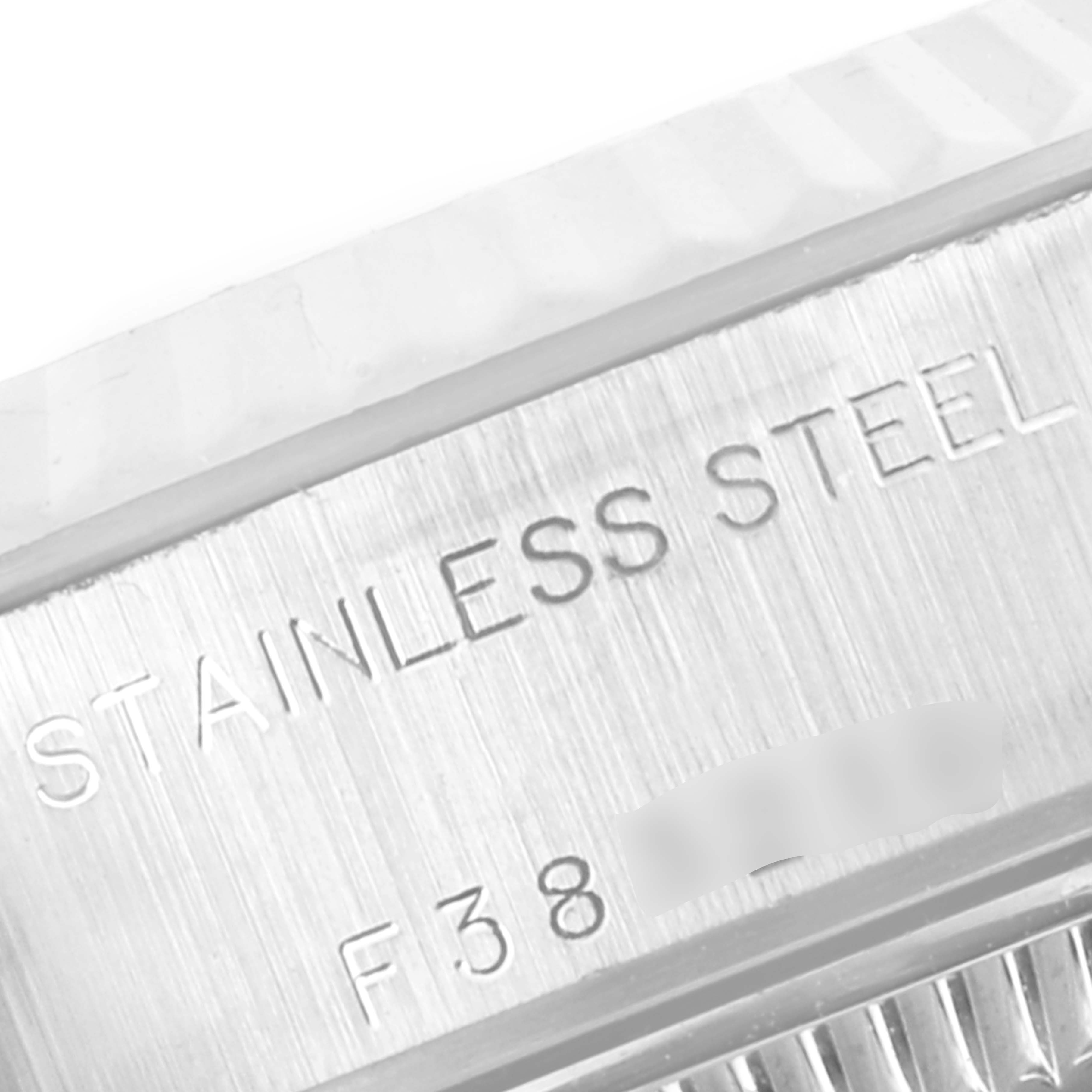 The image shows a close-up of the stainless steel engraving on the bezel of a Rolex Datejust 79174 Women
s Stainless Steel Silver Dial 79174 Women
s Stainless Steel Silver Dial watch.
