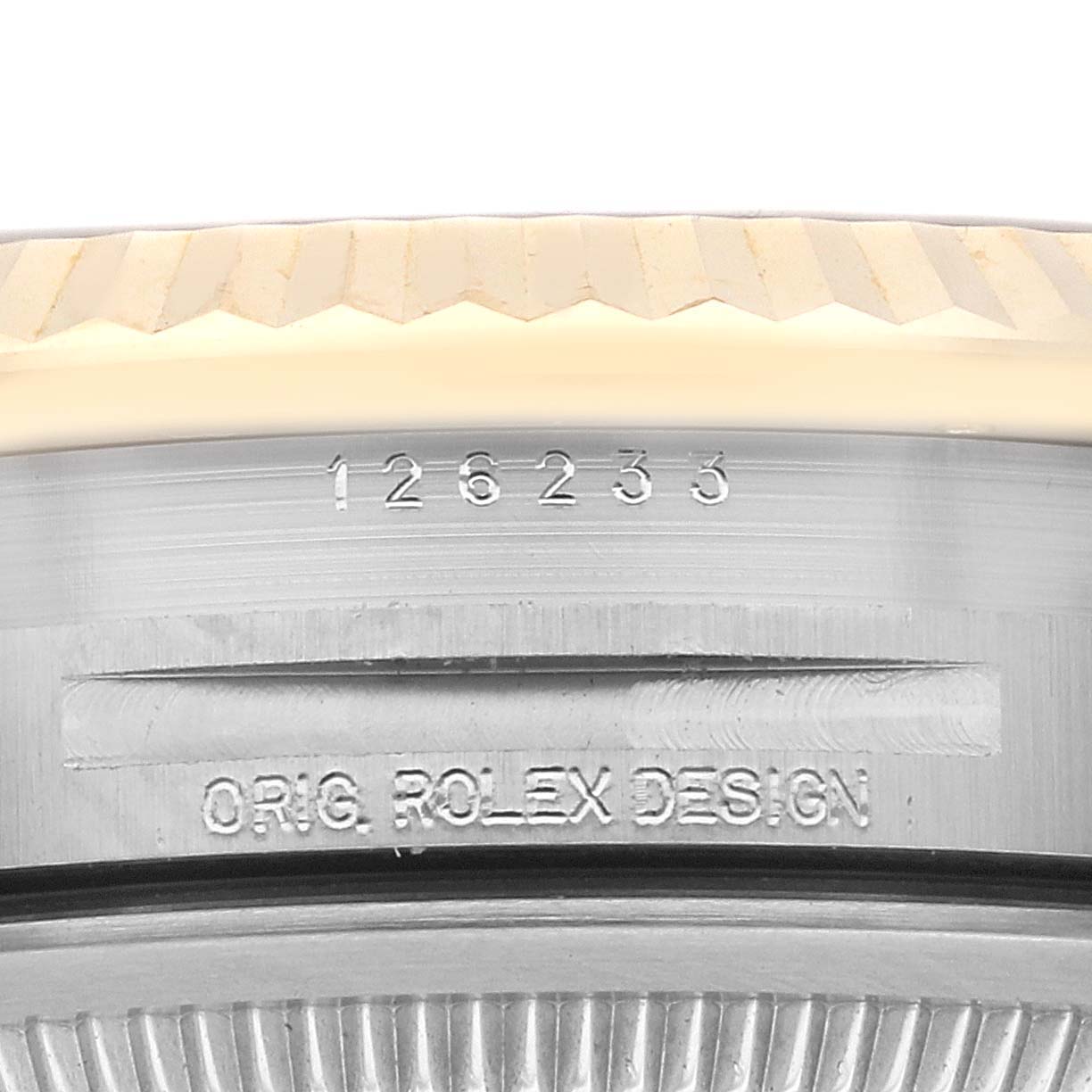 This image shows a close-up angle of the side of the Rolex Datejust 126233 Men's Steel and Gold (two tone) Champagne Dial 126233 Men's Steel and Gold (two tone) Champagne Dial model with the model number 126233 and "ORIG. ROLEX DESIGN" engraving.