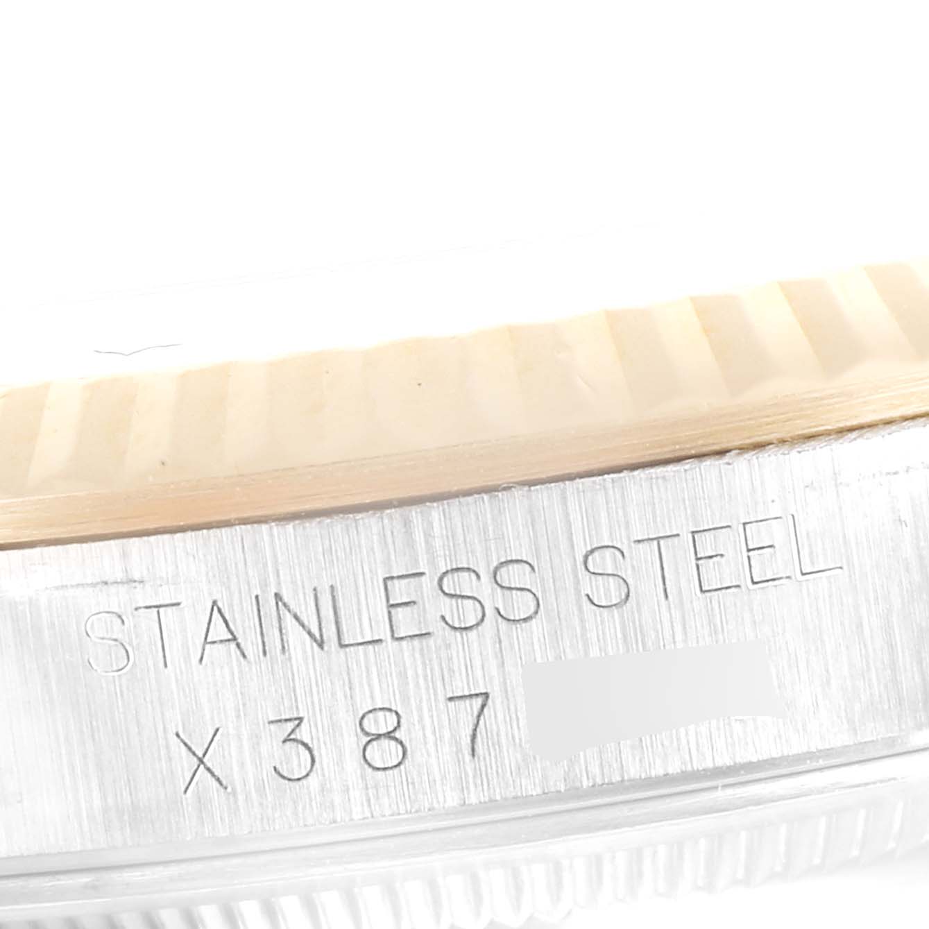 The image shows a close-up angle of the outside case back of a Rolex Datejust 16233 Men's Steel and Gold (two tone) Champagne Dial 16233 Men's Steel and Gold (two tone) Champagne Dial, highlighting the "Stainless Steel" engraving.