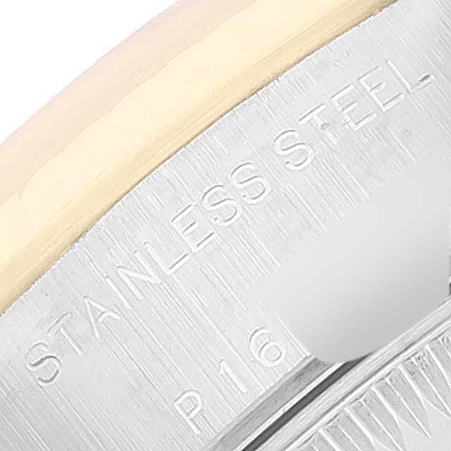 This image shows a close-up of the stainless steel and gold parts of the Rolex Datejust 79173 Women's Steel and Gold (two tone) Champagne Dial 79173 Women's Steel and Gold (two tone) Champagne Dial watch bezel and case with some engraved text.