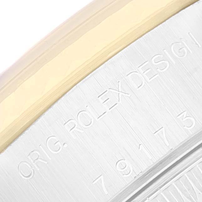This close-up image shows the engraved side of the case of a Rolex Datejust 79173 Women's Steel and Gold (two tone) Champagne Dial 79173 Women's Steel and Gold (two tone) Champagne Dial watch.