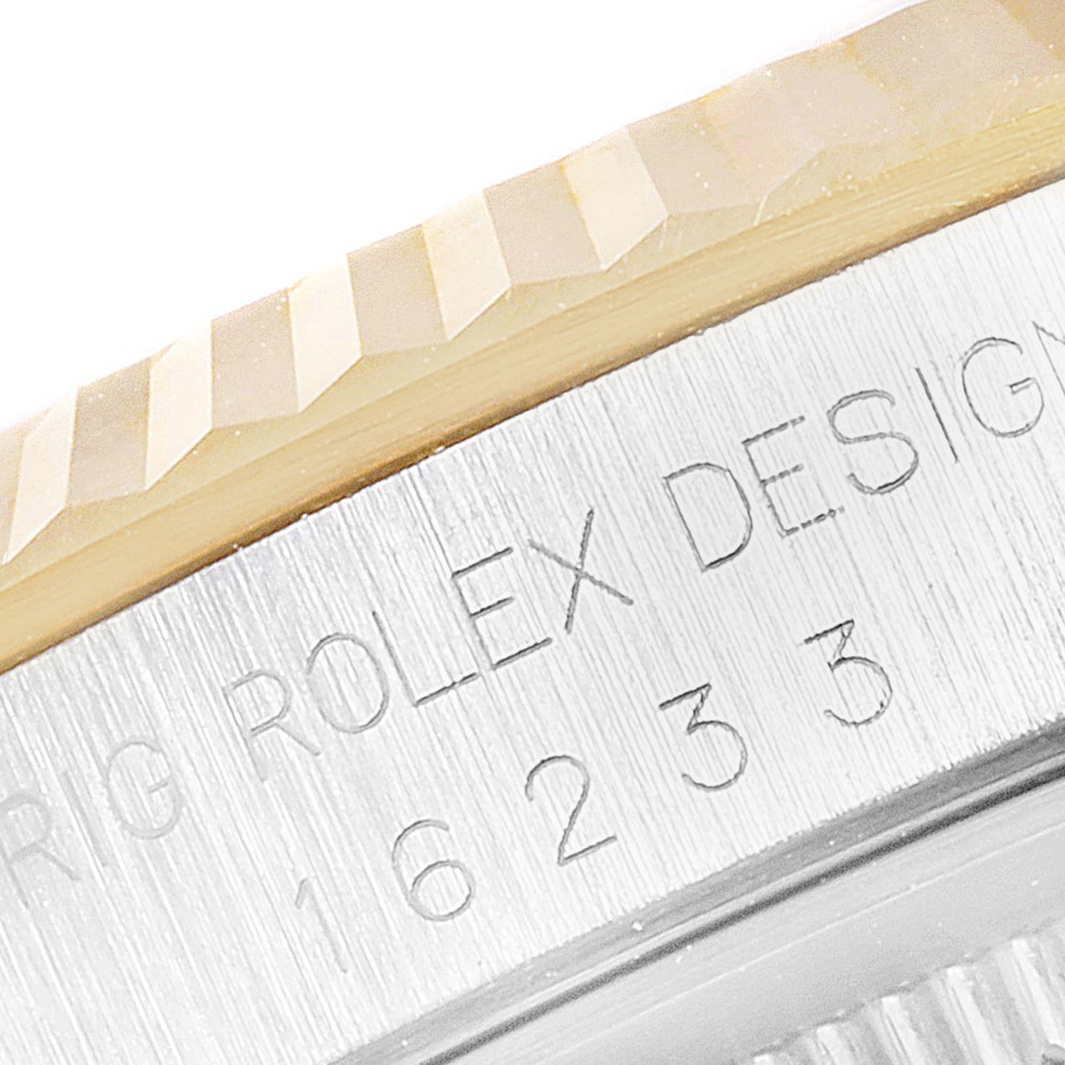 The image shows a close-up of the bezel and engraved side of a Rolex Datejust 16233 Men's Steel and Gold (two tone) White Dial 16233 Men's Steel and Gold (two tone) White Dial model.