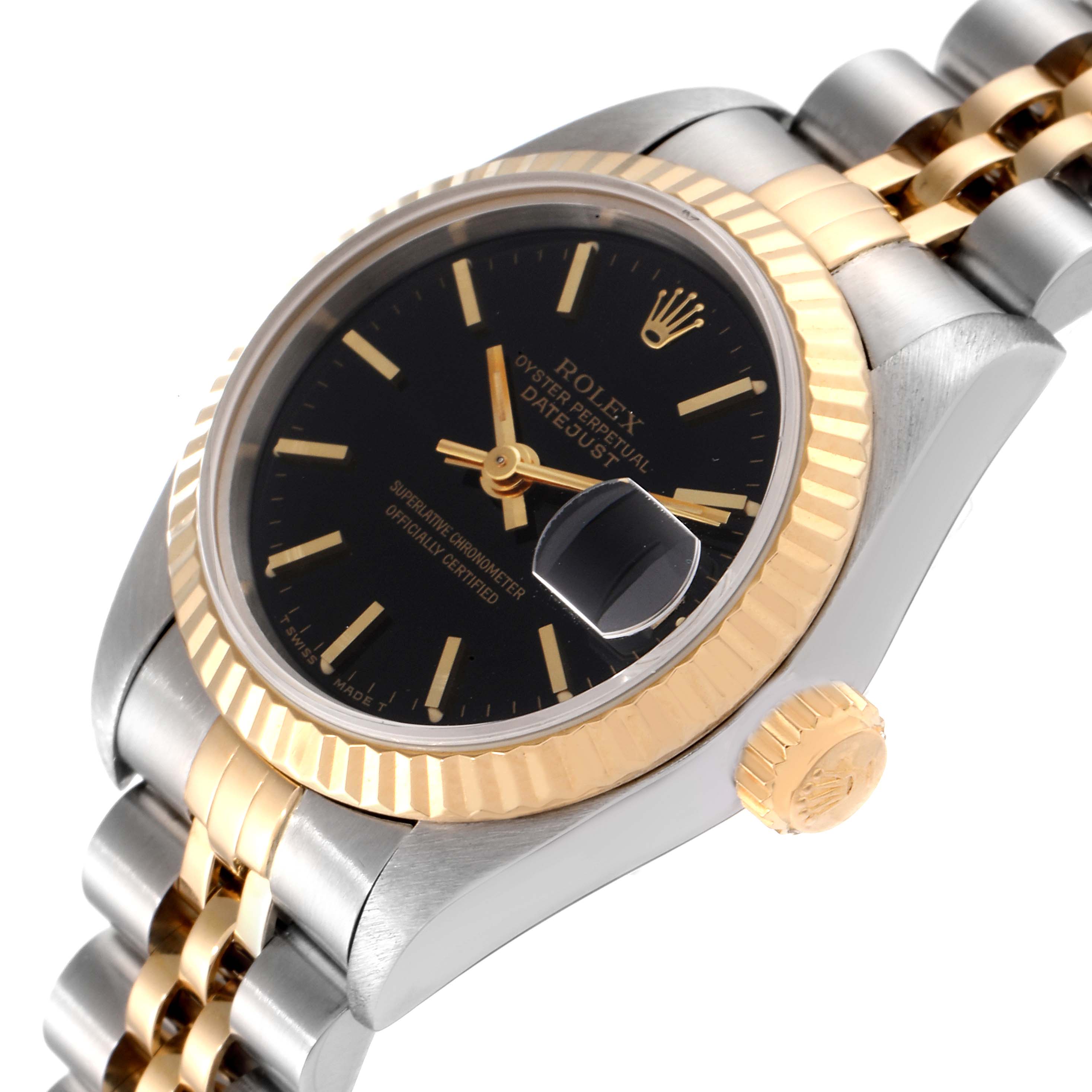 The Rolex Datejust 69173 Women
s Steel and Gold (two tone) Black Dial 69173 Women
s Steel and Gold (two tone) Black Dial watch is shown at an angle highlighting the black dial, fluted bezel, date magnifier, and two-tone bracelet.