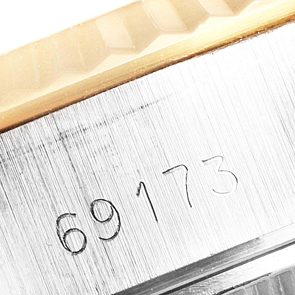 This image shows a close-up of the model number engraving and part of the bezel of the Rolex Datejust 69173 Women's Steel and Gold (two tone) Champagne Dial 69173 Women's Steel and Gold (two tone) Champagne Dial watch.