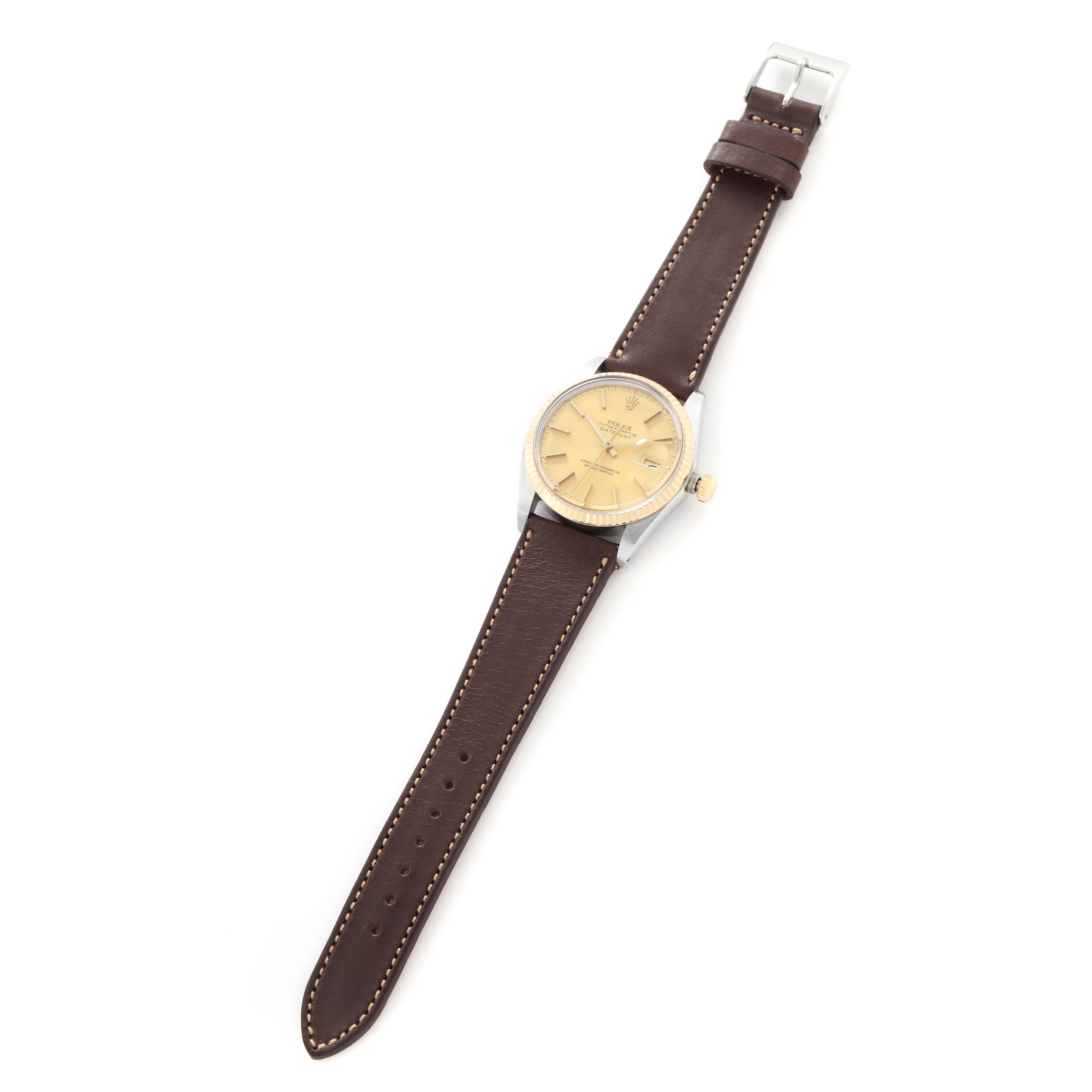 The Rolex Datejust model 1601 men
s watch is shown from an overhead angle, displaying its face, leather strap, and buckle.