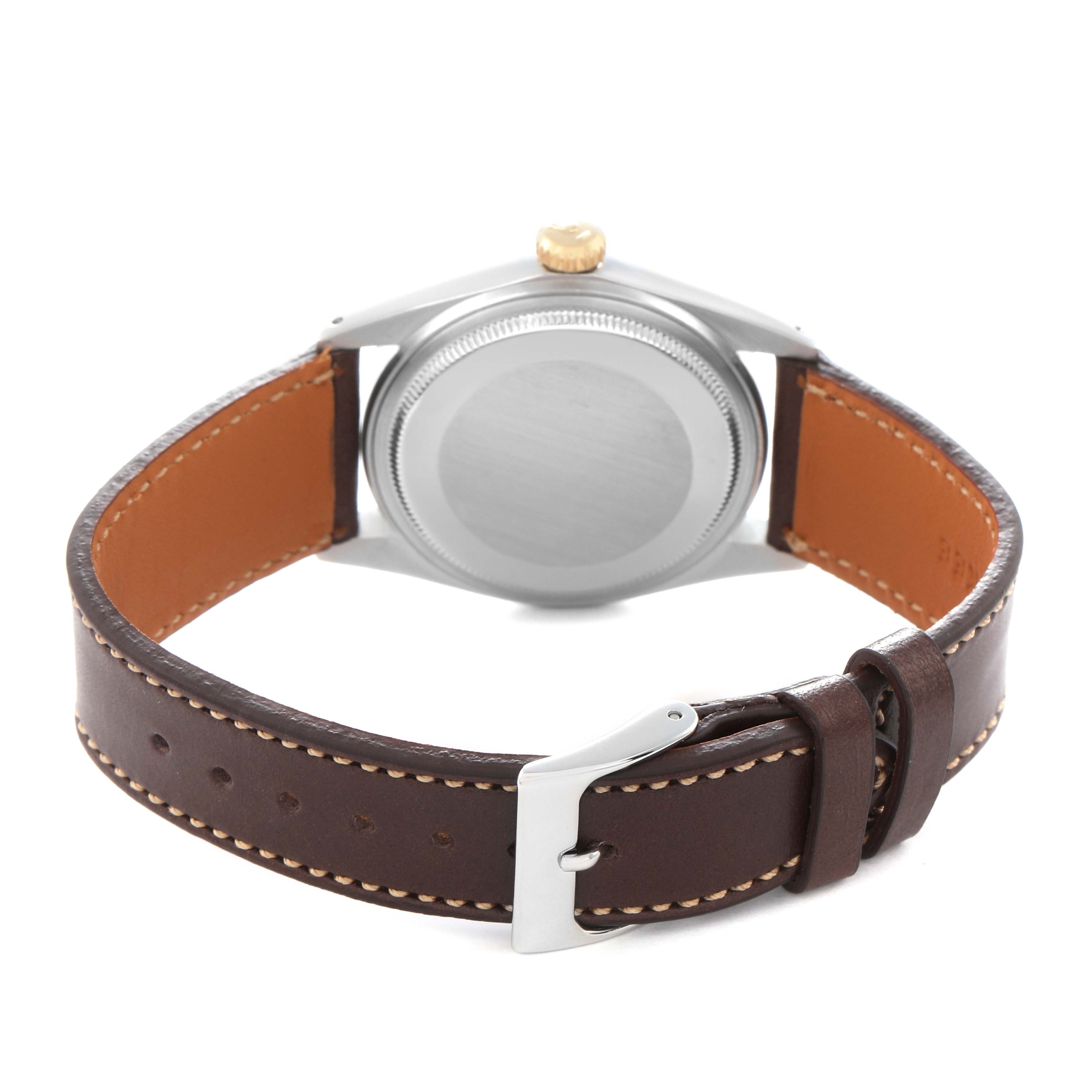 The image shows the back view of a Rolex Datejust model 1601 men
s watch, highlighting the case back, crown, and brown leather strap with a buckle.