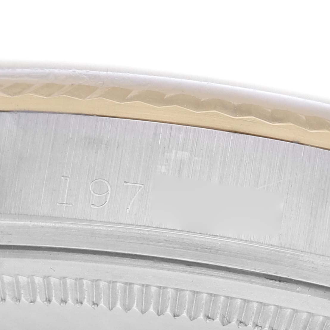 The image shows a close-up of the bezel and engraved serial number on a Rolex Datejust 1601 men
s watch.