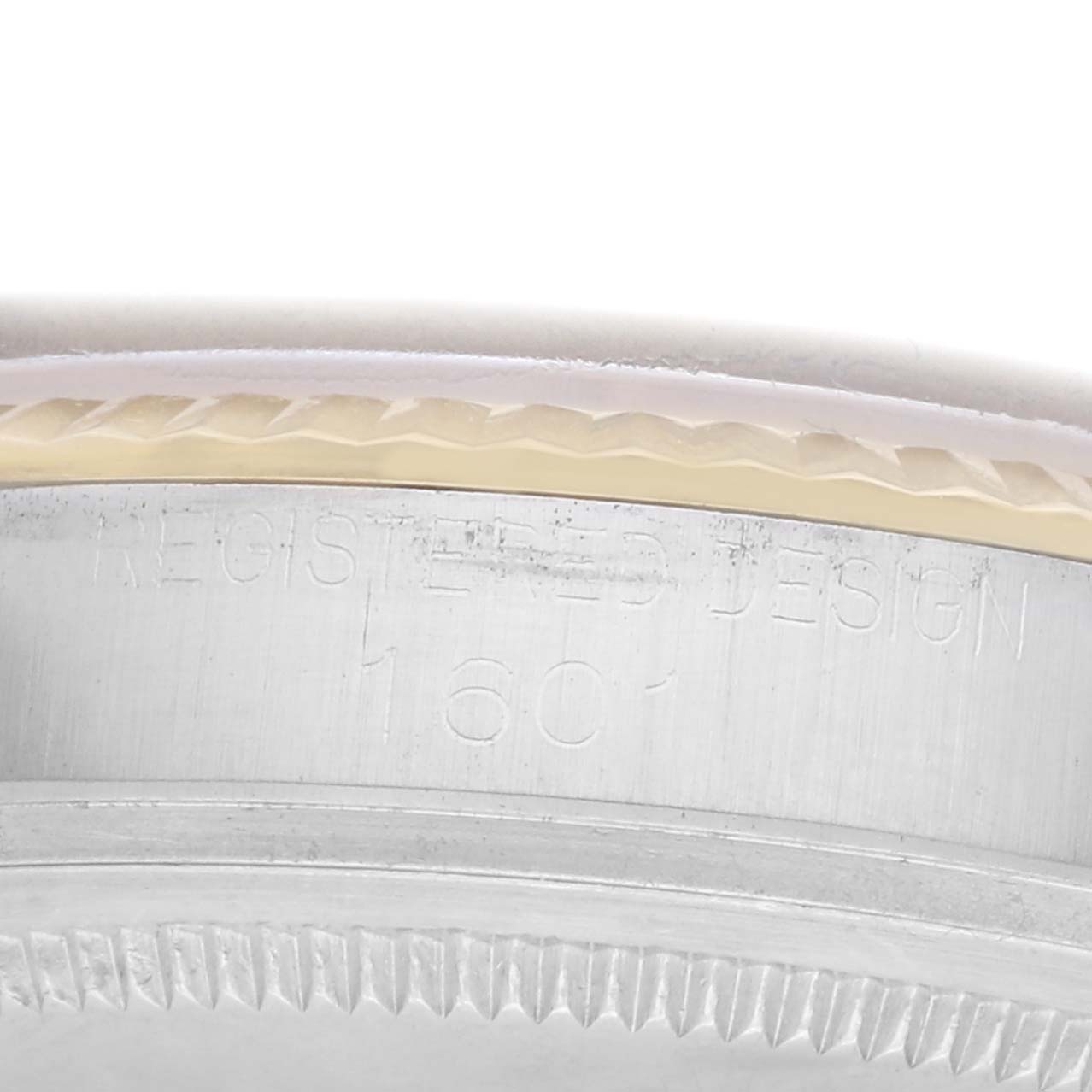 The image shows a side view of the Rolex Vintage Collection 1601 Men
s Steel and Gold (two tone) Yellow Dial
s engraved bezel and case edge.