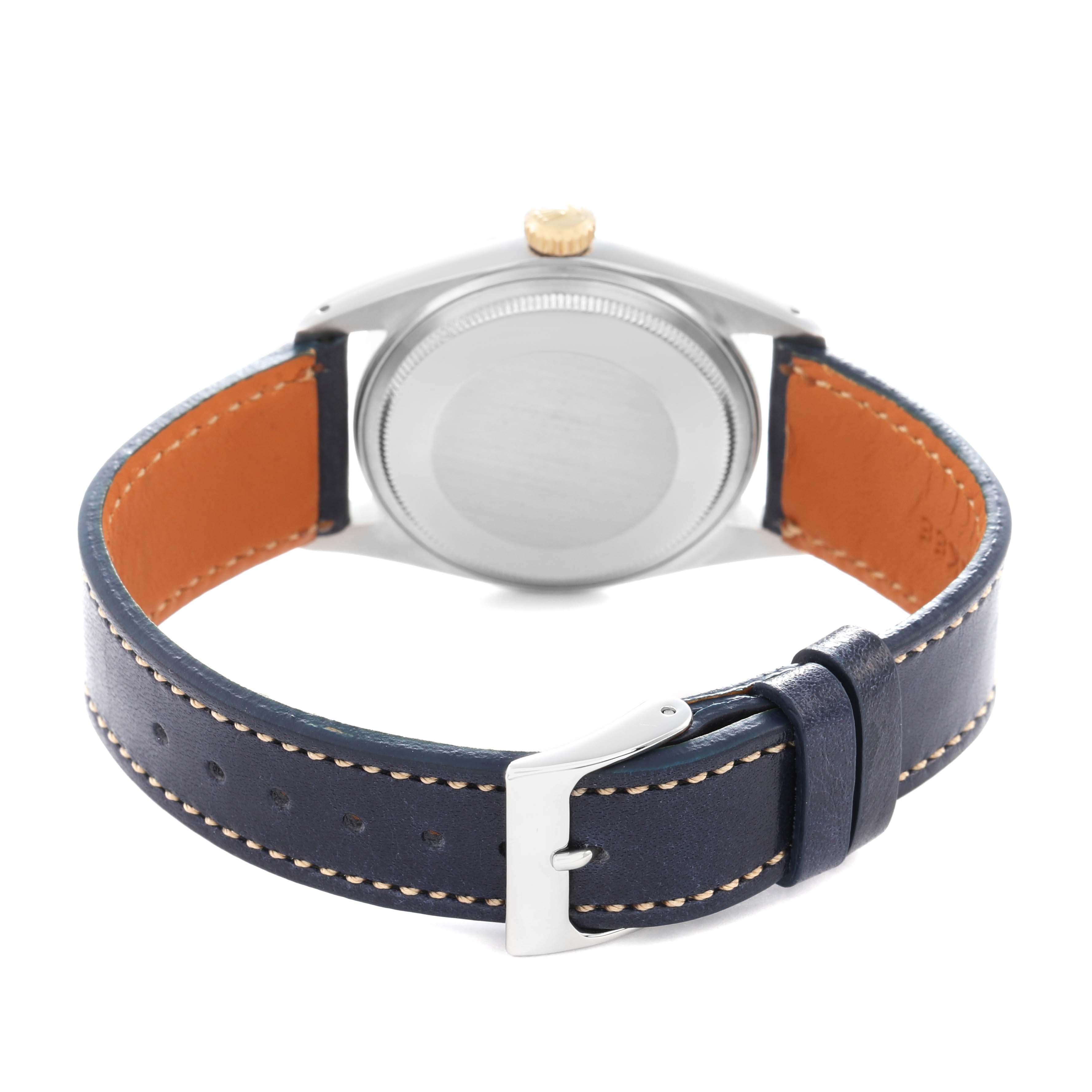 The Rolex Vintage Collection 1601 Men
s Steel and Gold (two tone) Yellow Dial model is shown from the back, highlighting the case back, blue leather strap, and clasp.