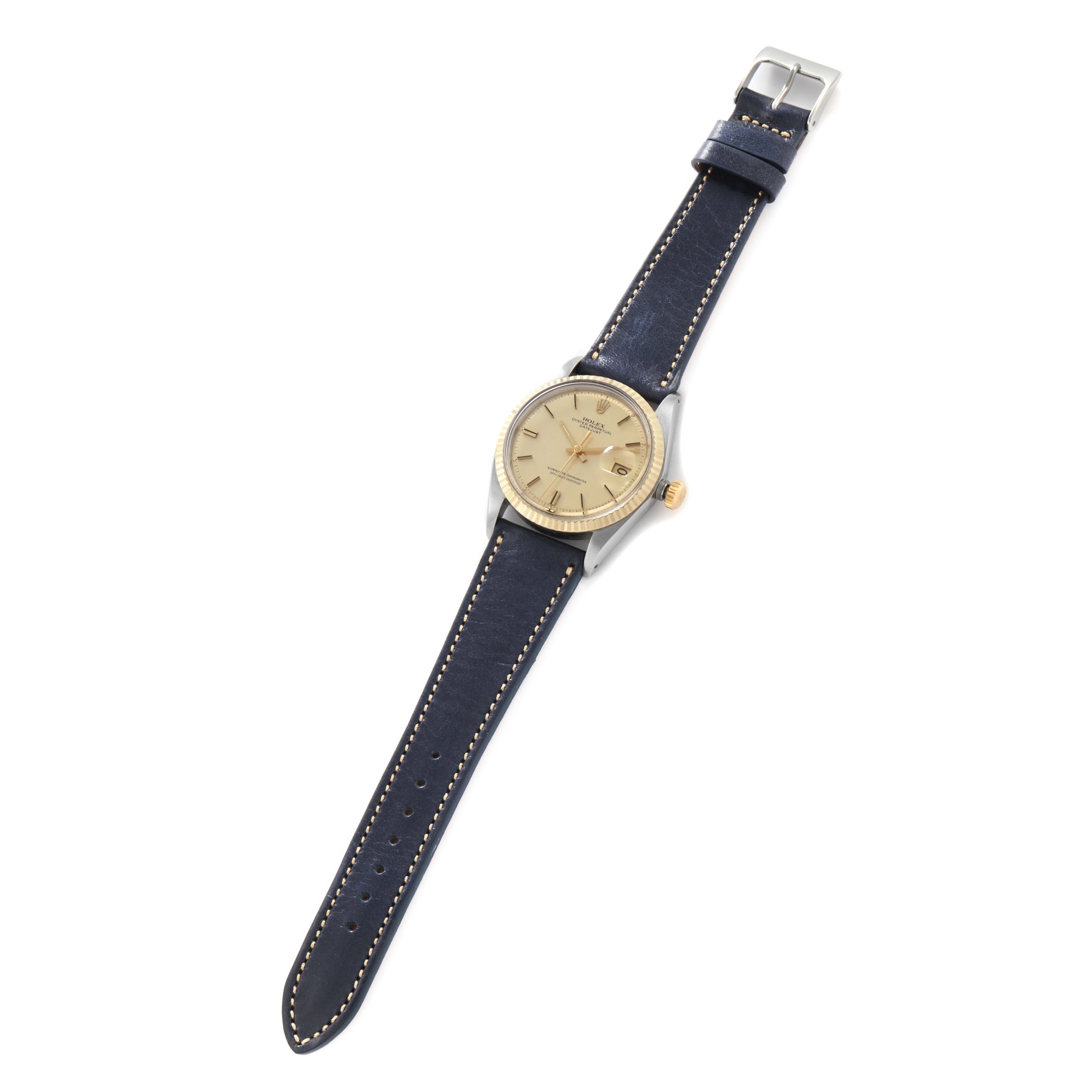 The Rolex Vintage Collection 1601 Men
s Steel and Gold (two tone) Yellow Dial watch is shown from a top view, displaying the face, entire strap, and buckle.