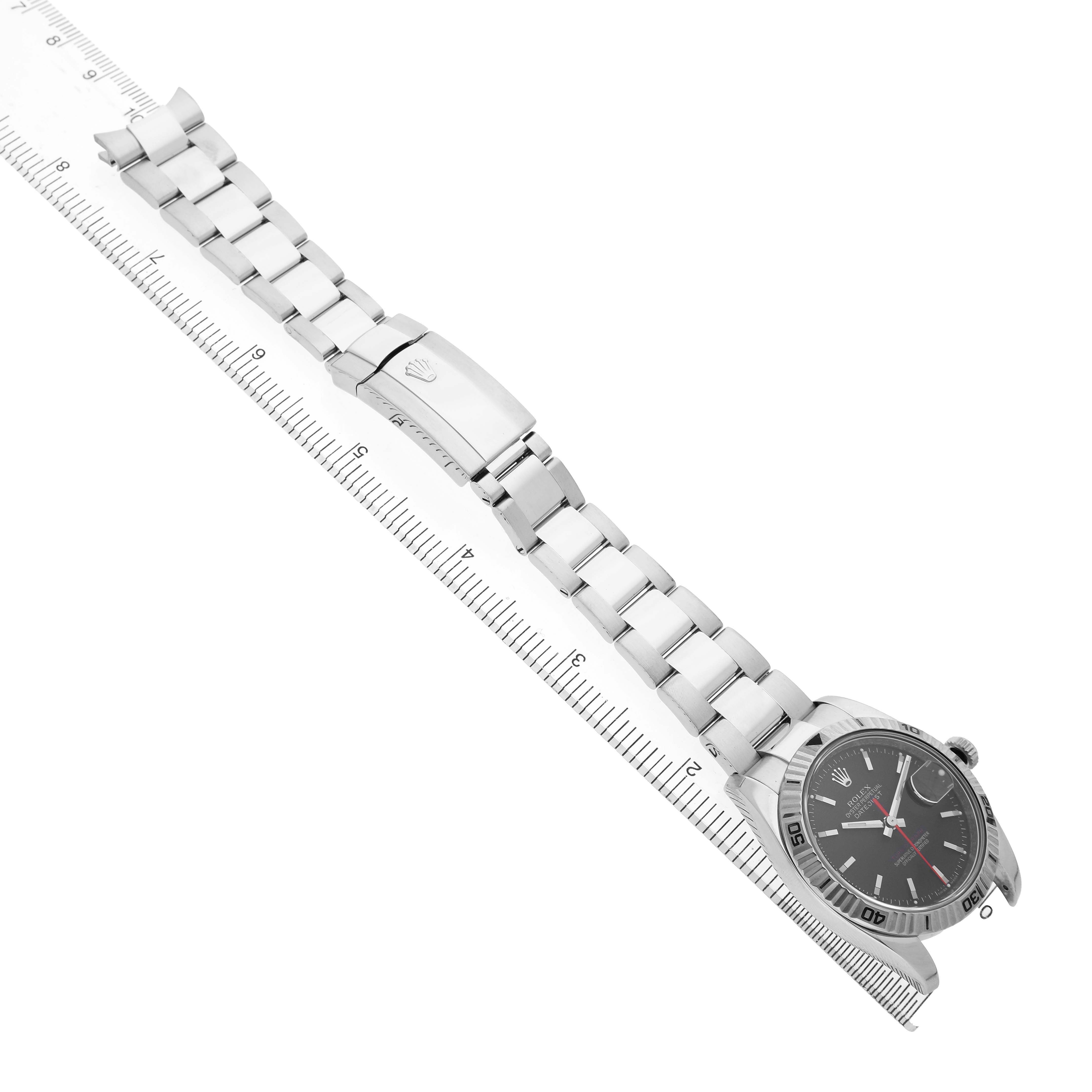 The image shows the Rolex Datejust 116264 Men's Stainless Steel Black Dial watch from an angled top view, highlighting the bracelet and clasp along with the watch face.
