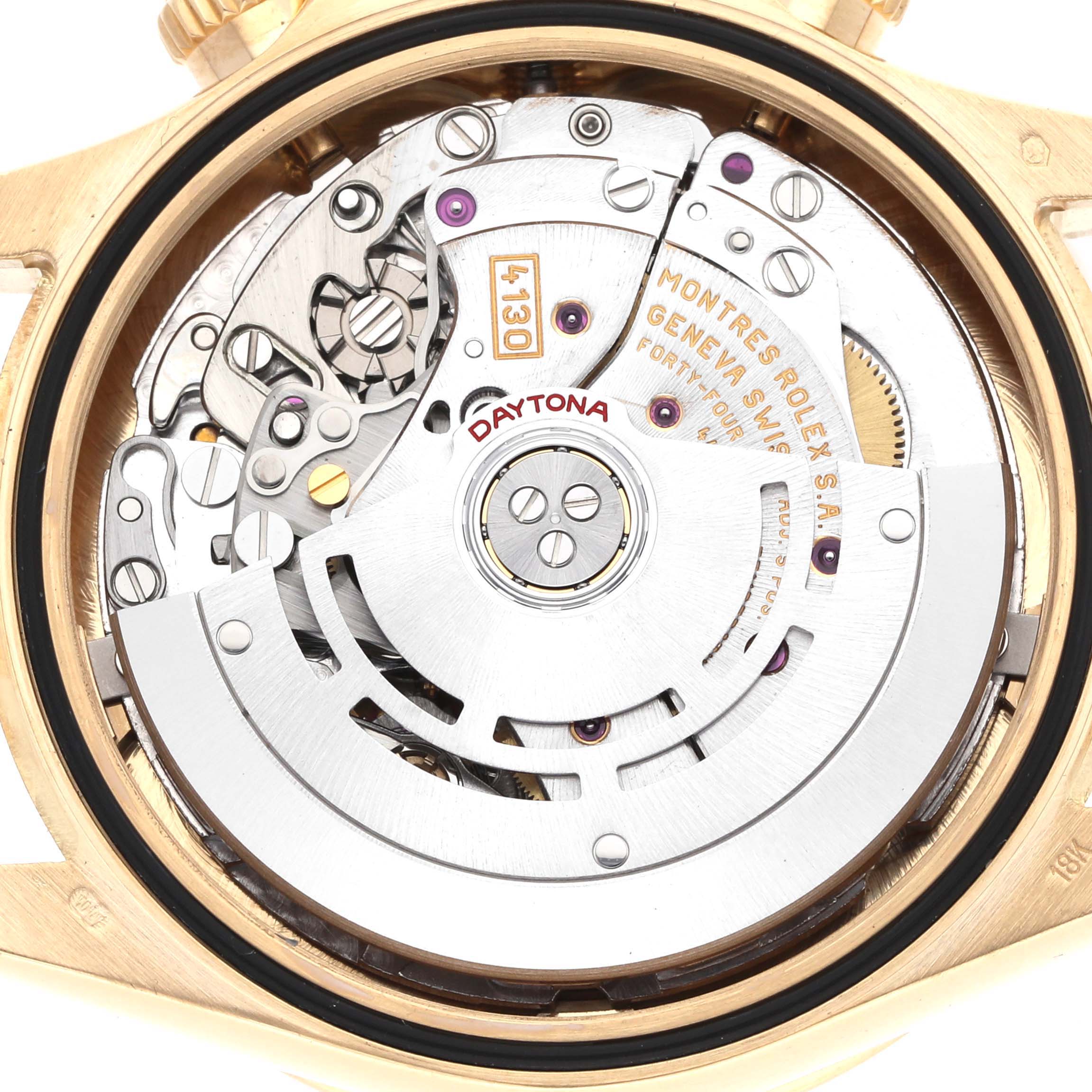 The image shows the movement of a Rolex Daytona model 116528, focusing on the intricate inner mechanics from a back view angle.