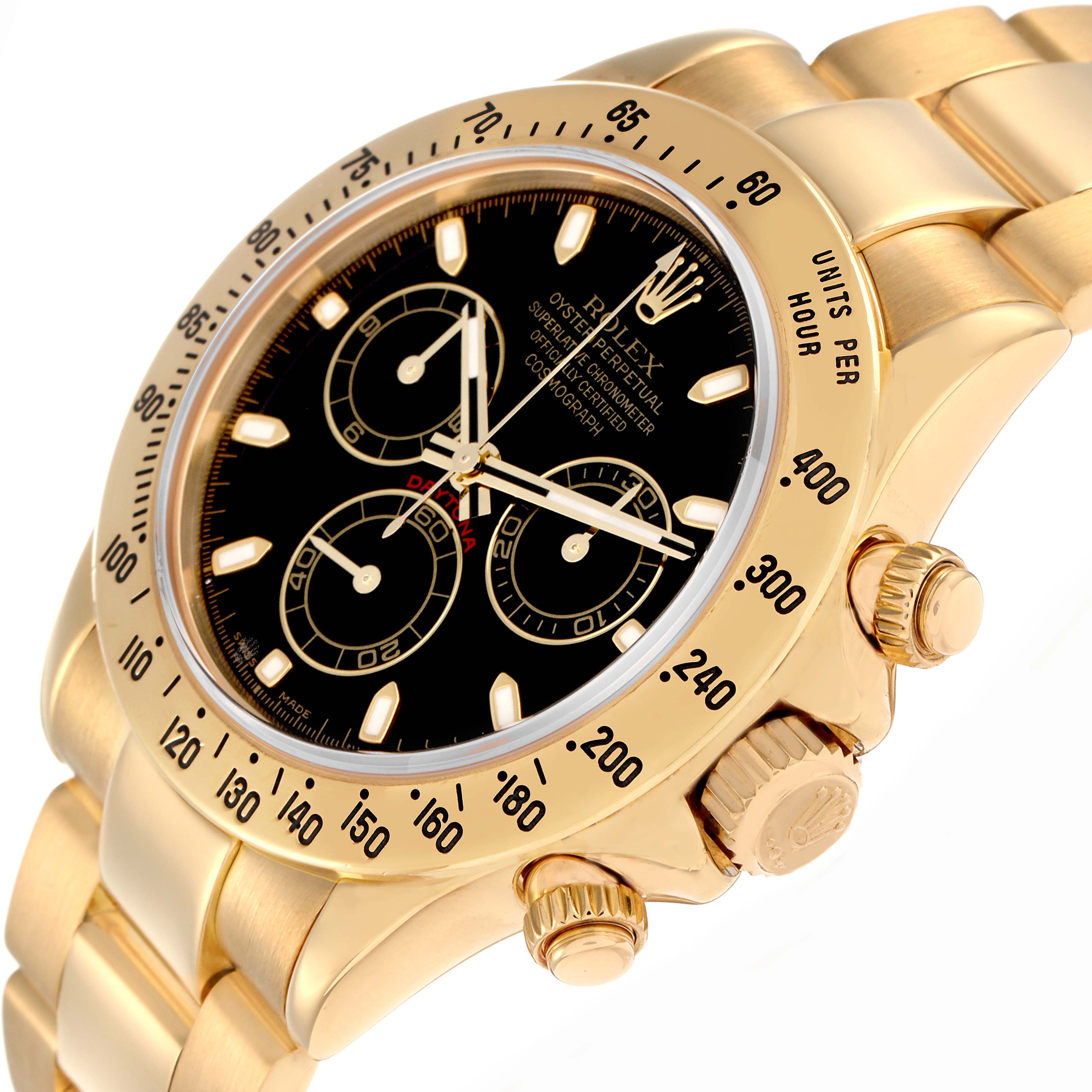 The Rolex Daytona model 116528 is shown at an angle highlighting the gold case, bezel with tachymetric scale, crown, pushers, and part of the bracelet.