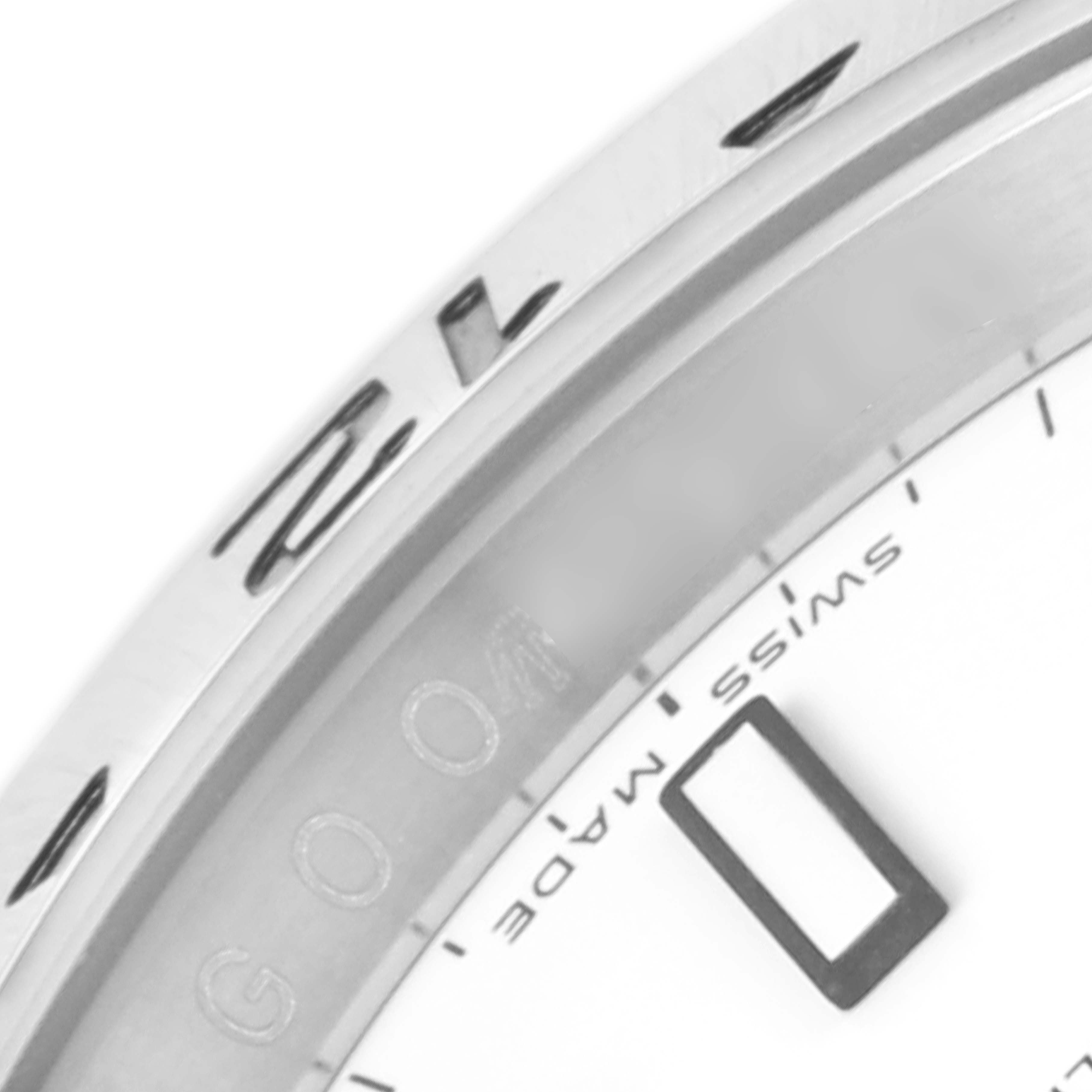 This close-up shot of the Rolex Explorer 16570 Men's Stainless Steel White Dial 16570 Men's Stainless Steel White Dial model showcases the edge of the dial, index markers, and part of the bezel.