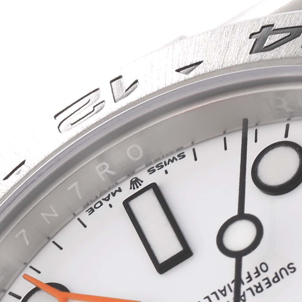 Close-up of the dial and bezel of the Rolex Explorer 226570 Men's Stainless Steel White Dial 226570 Men's Stainless Steel White Dial, showing part of the face, markers, and text.