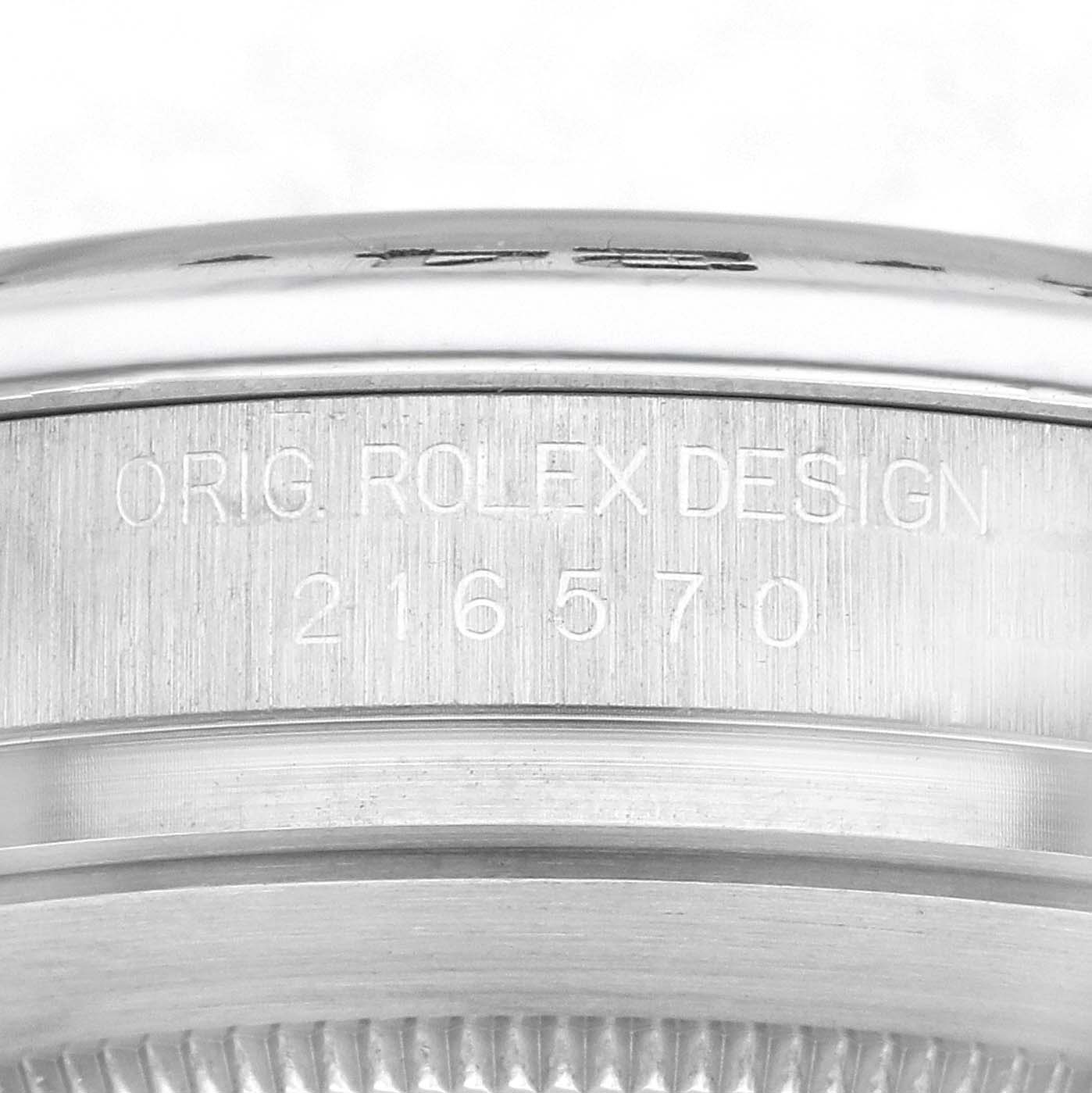 The image shows a close-up side view of the case edge of the Rolex Explorer model 216570, featuring the engraved design details.