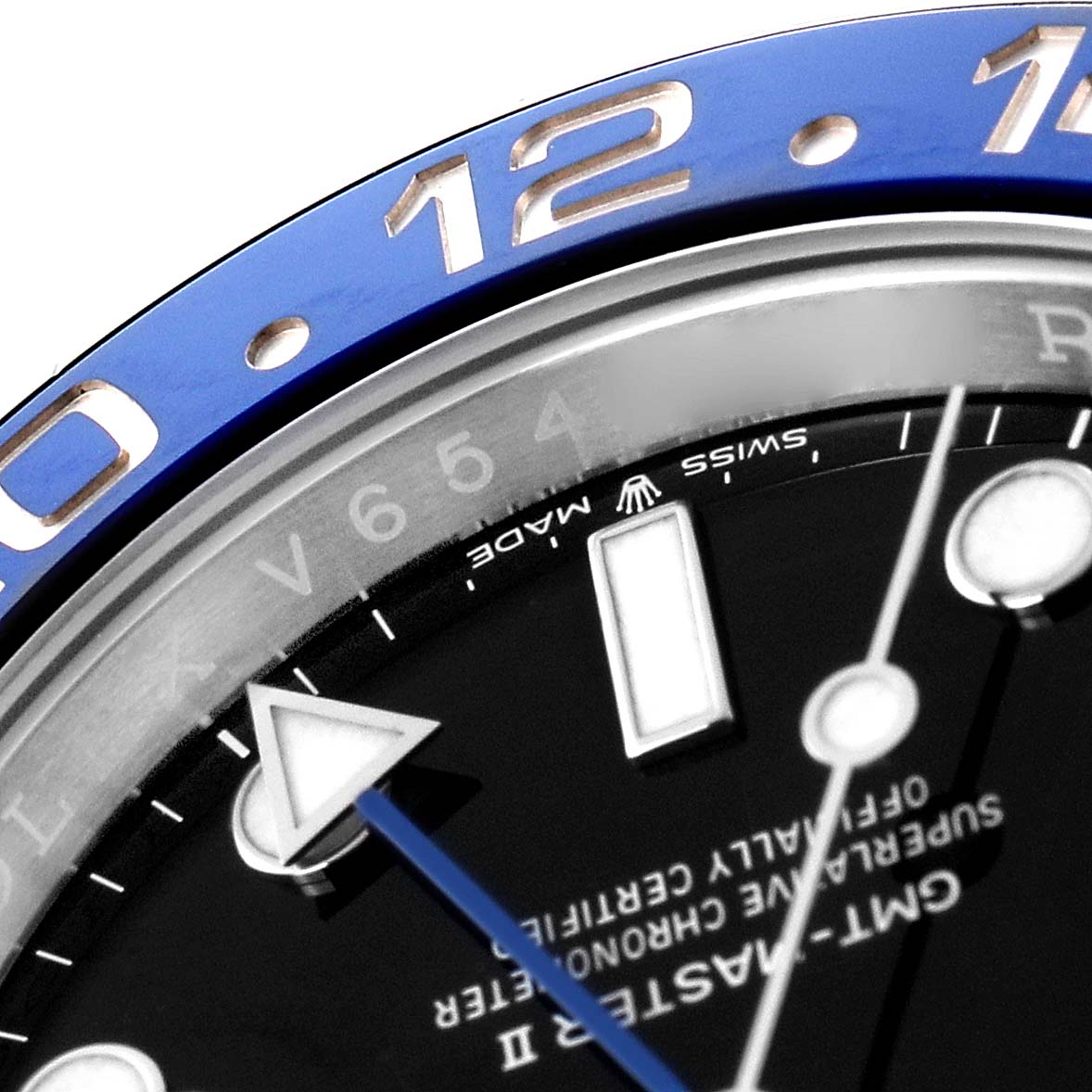 The image shows a close-up of the Rolex GMT-Master II model 126710, focusing on the bezel with blue and silver numbering and part of the black dial.