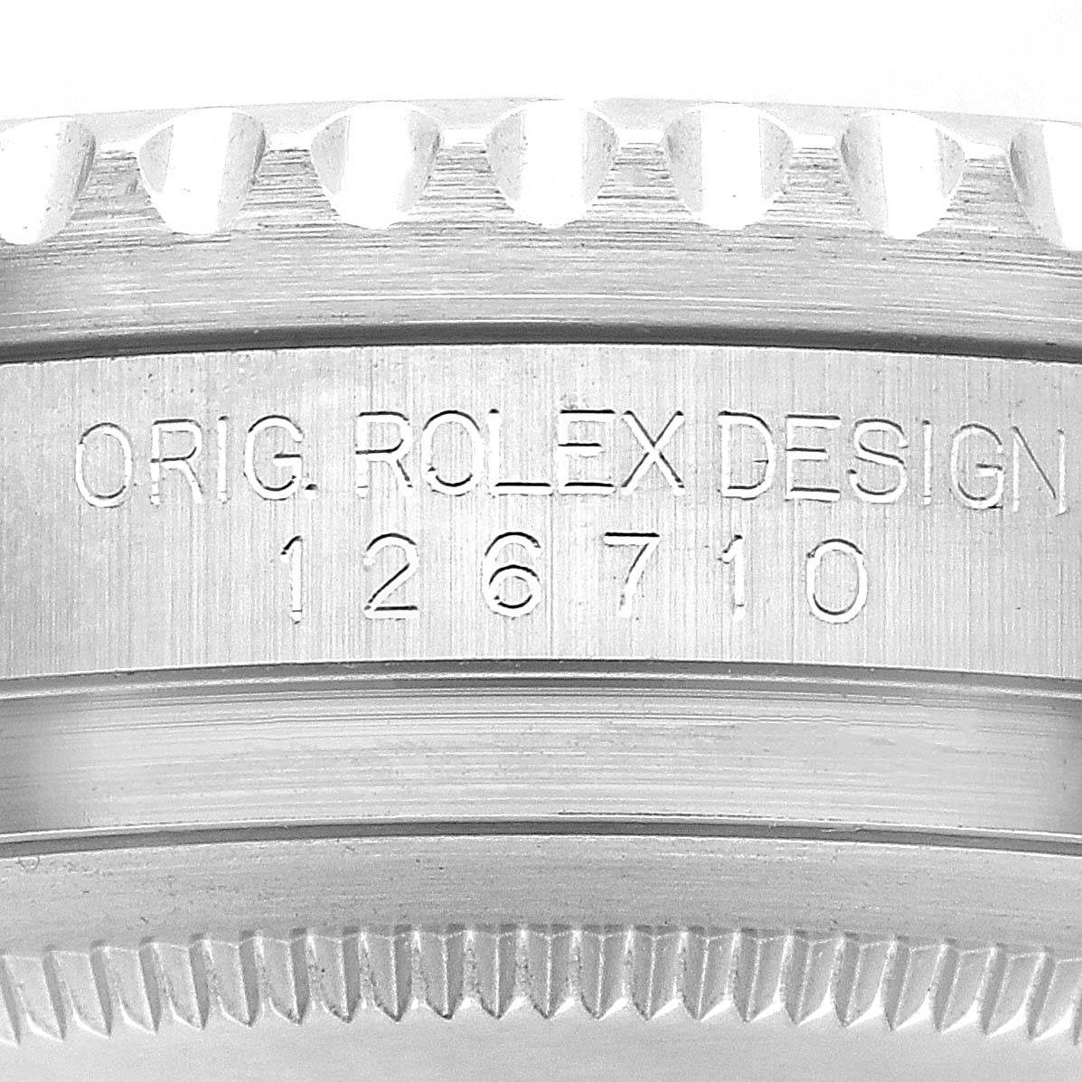 The image shows a close-up of the side of the Rolex GMT-Master model 126710, highlighting the engraving on the case with model details.