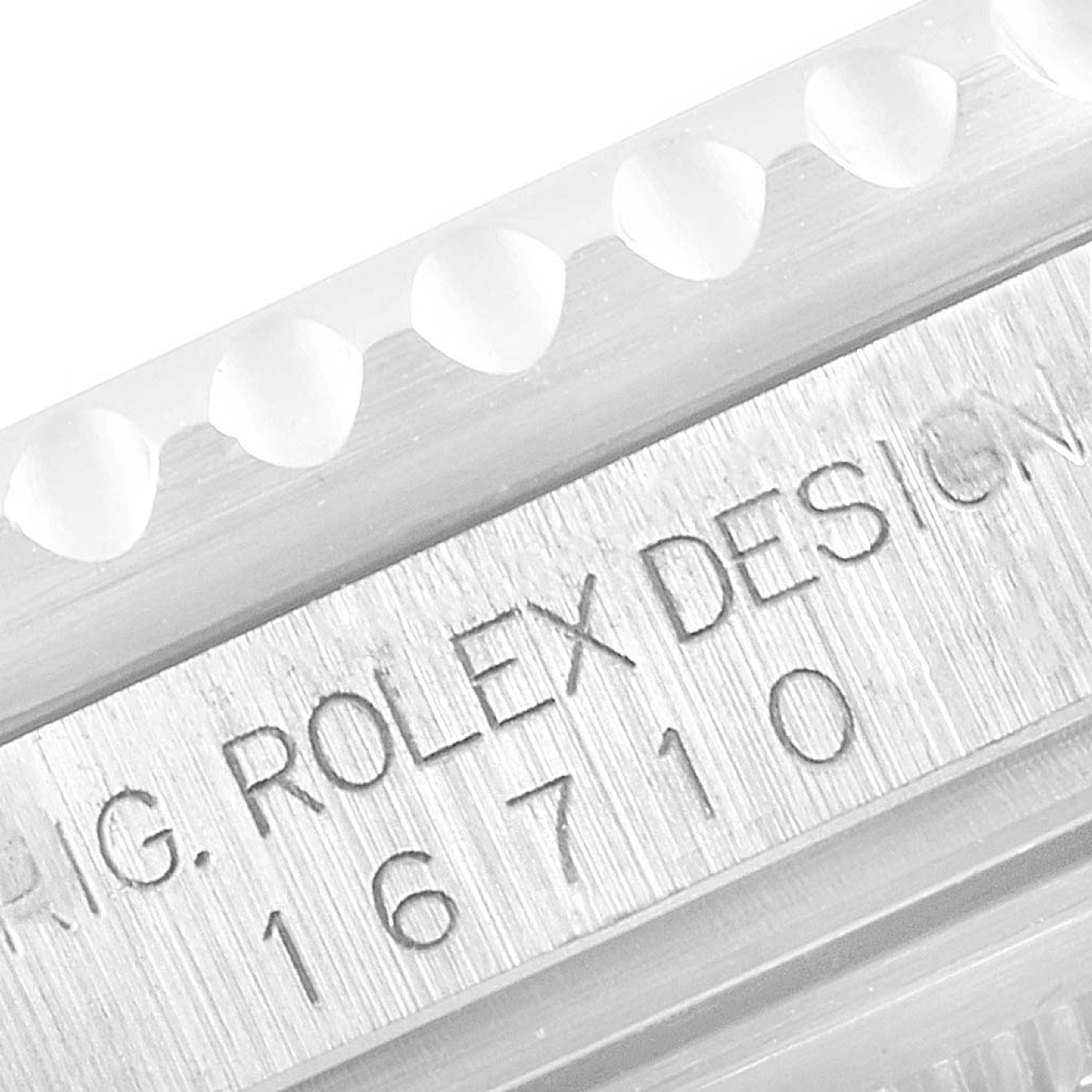 The image shows a close-up view of the engraving and bezel teeth on a Rolex GMT-Master 16710 Men's Stainless Steel Black Dial 16710 Men's Stainless Steel Black Dial model 16710.
