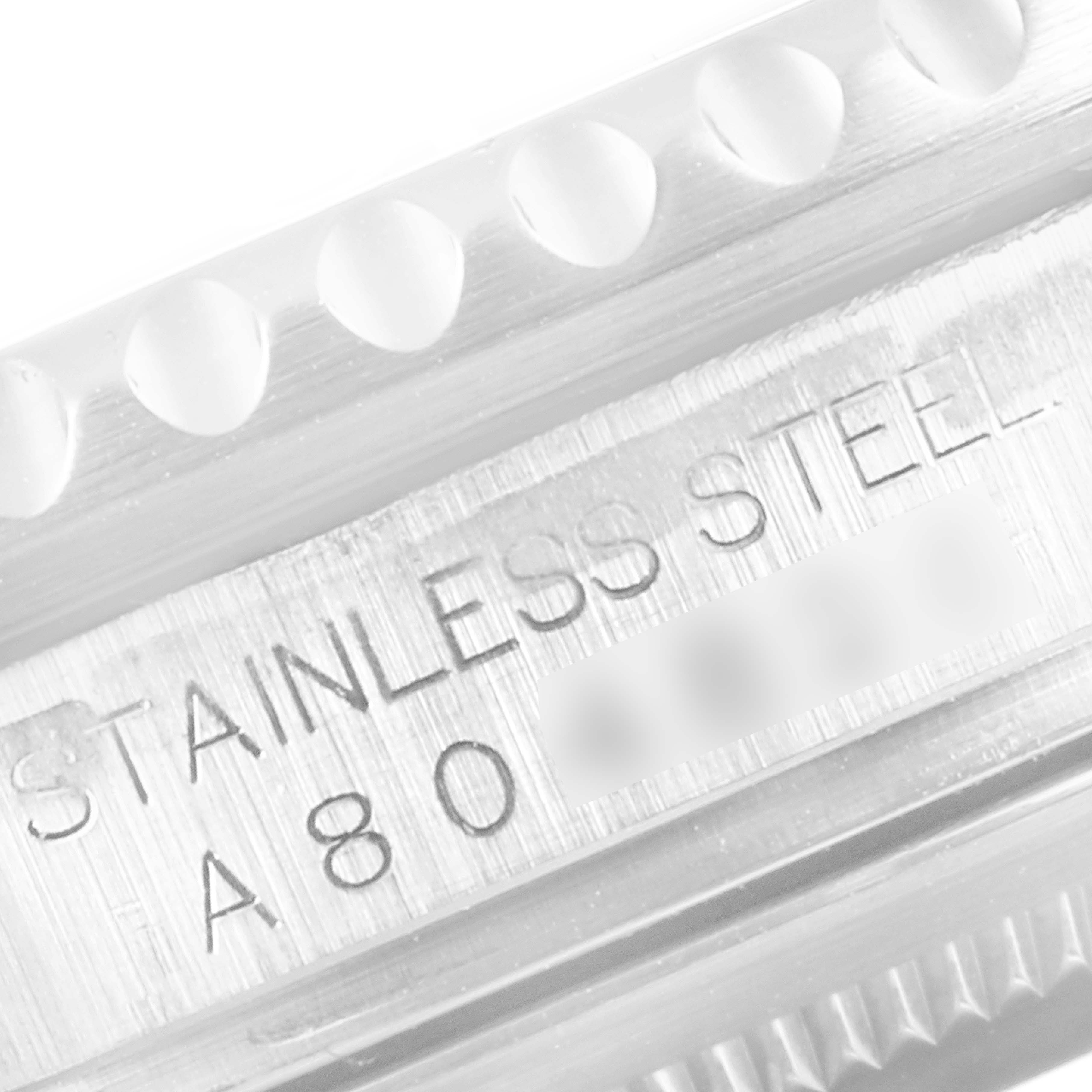 This close-up image of the Rolex GMT-Master 16710 Men's Stainless Steel Black Dial 16710 Men's Stainless Steel Black Dial watch shows the engraved stainless steel text on the case.