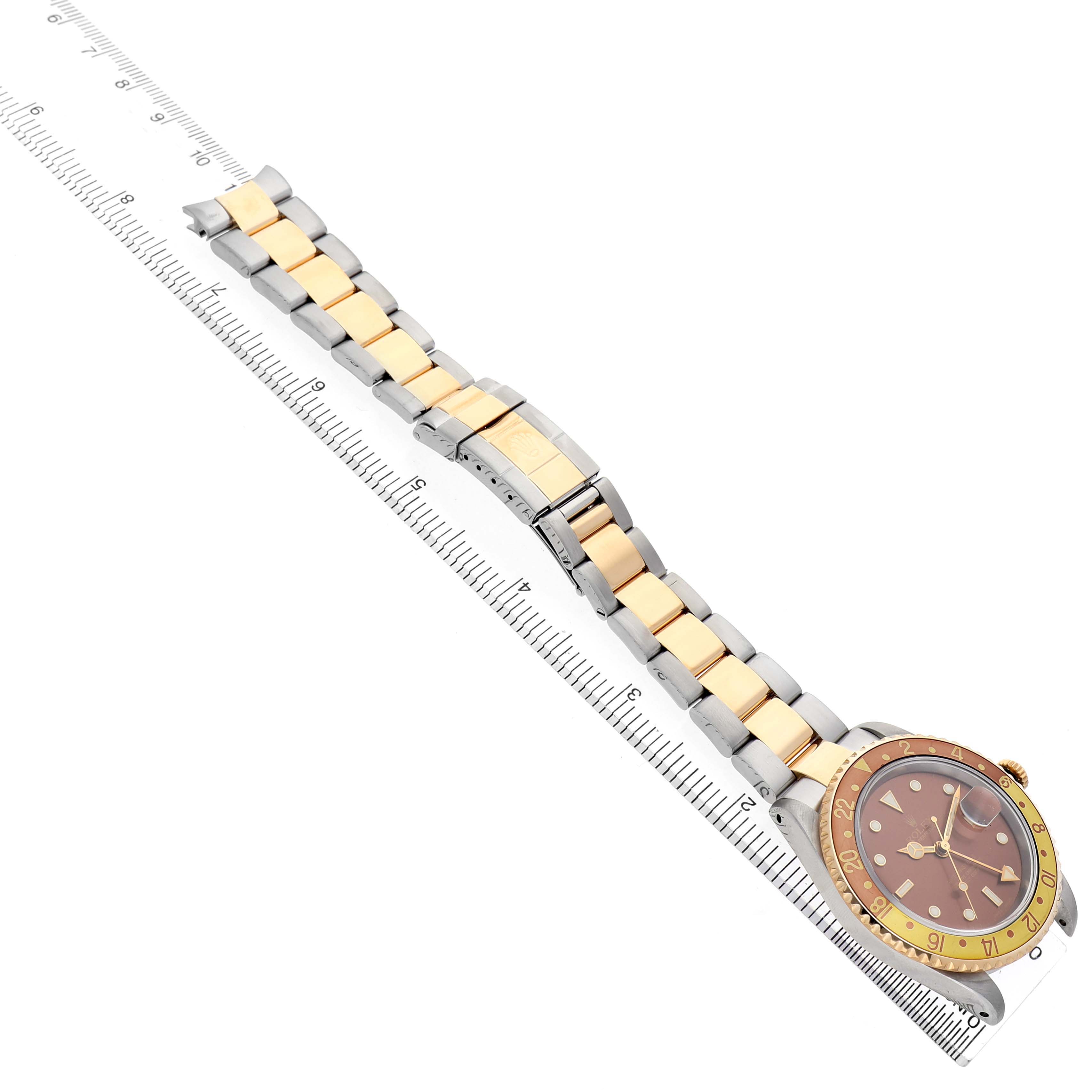 The Rolex GMT-Master 16713 Men's Stainless Steel Brown Dial watch is shown from a top angle, displaying the face, bezel, and two-tone bracelet.