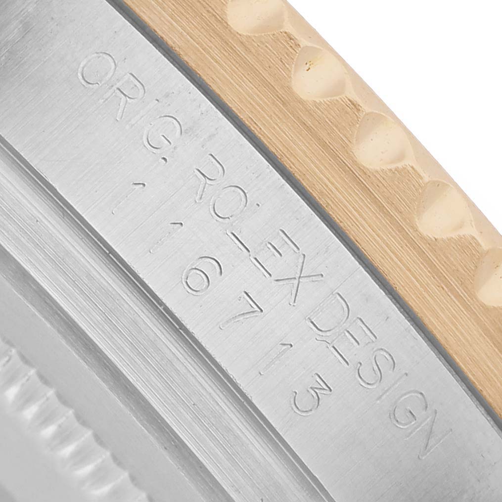 The image shows a close-up of the side of a Rolex GMT-Master 116713 Men's Steel and Gold (two tone) Black Dial watch, highlighting the engraved reference number.