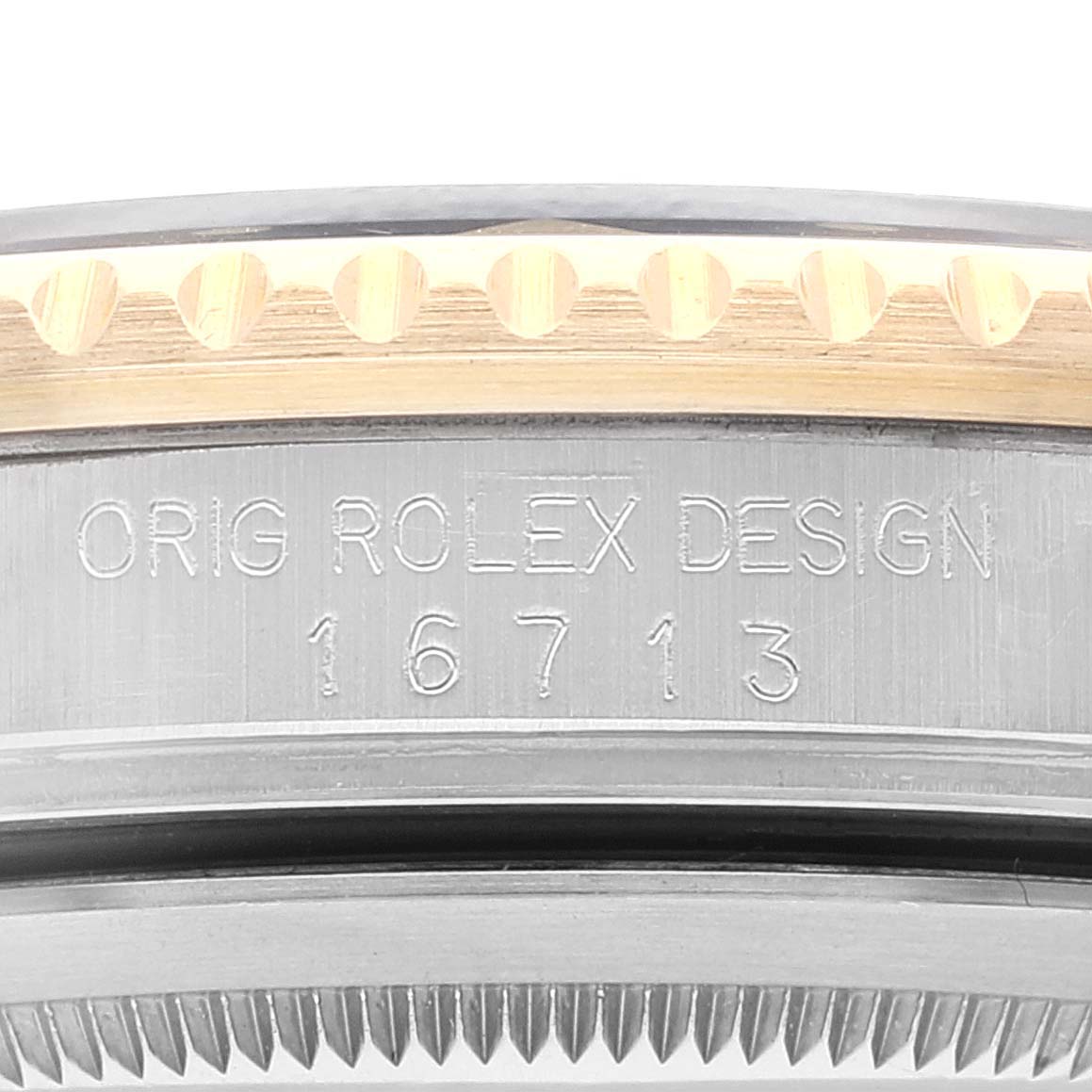 This close-up image shows the case side of a Rolex GMT-Master 16713 Men's Steel and Gold (two tone) Black Dial 16713 Men's Steel and Gold (two tone) Black Dial watch, highlighting its reference number 16713.