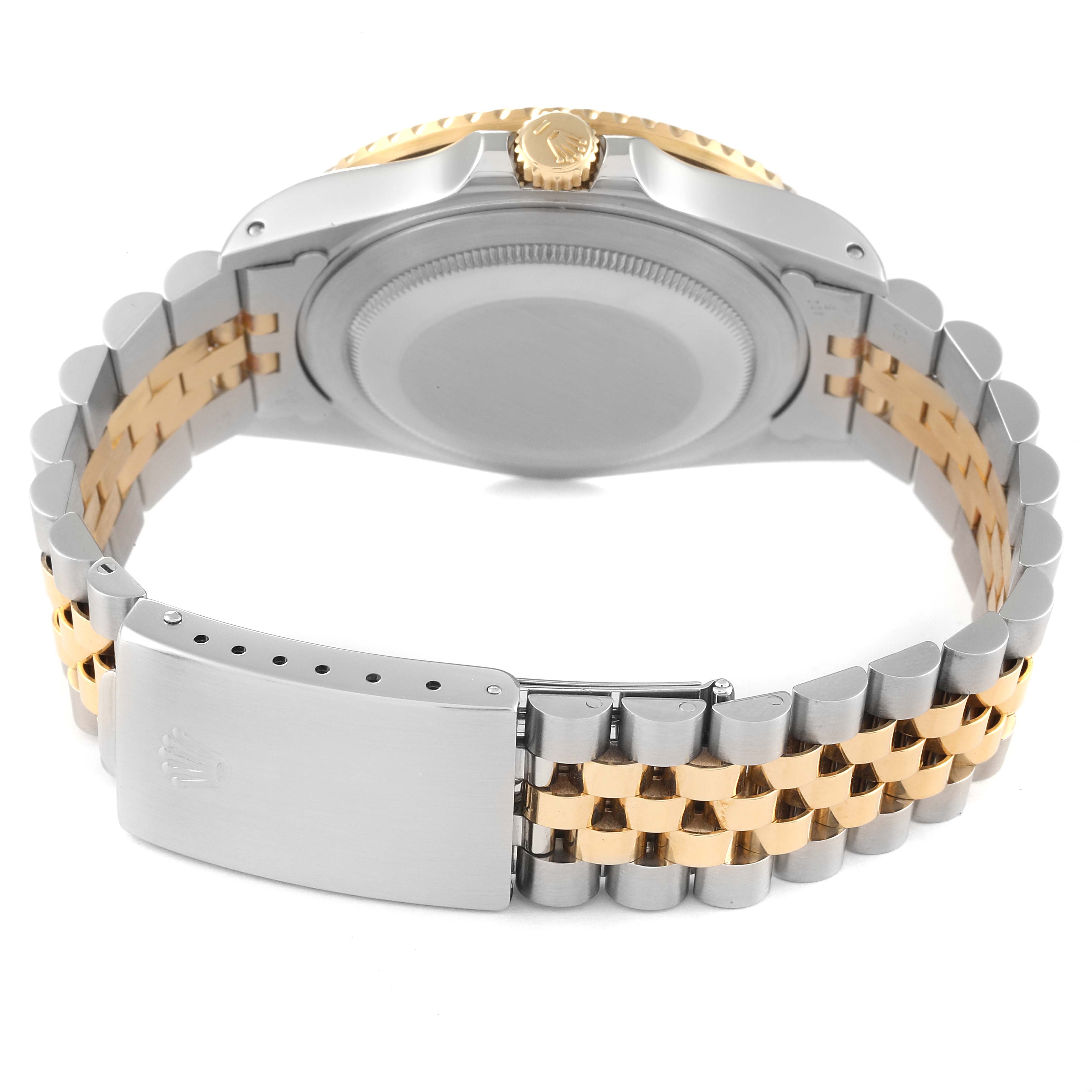 The Rolex GMT-Master 16713 Men's Steel and Gold (two tone) Black Dial 16713 Men's Steel and Gold (two tone) Black Dial watch is shown from the back, highlighting its case back, crown, and two-tone bracelet.