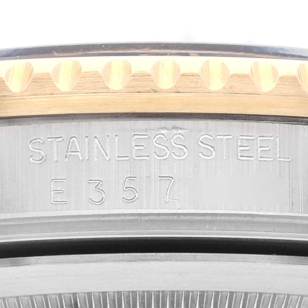 This image shows a close-up of the stainless steel case back and partially the bezel of a Rolex GMT-Master 16713 Men's Steel and Gold (two tone) Black Dial 16713 Men's Steel and Gold (two tone) Black Dial watch.