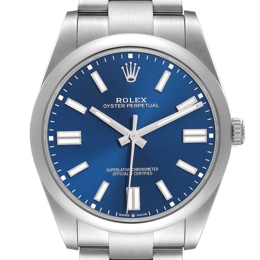 The image shows a Rolex Oyster Perpetual model 124300 men's watch from a front angle, highlighting the blue dial, hands, markers, and part of the bracelet.