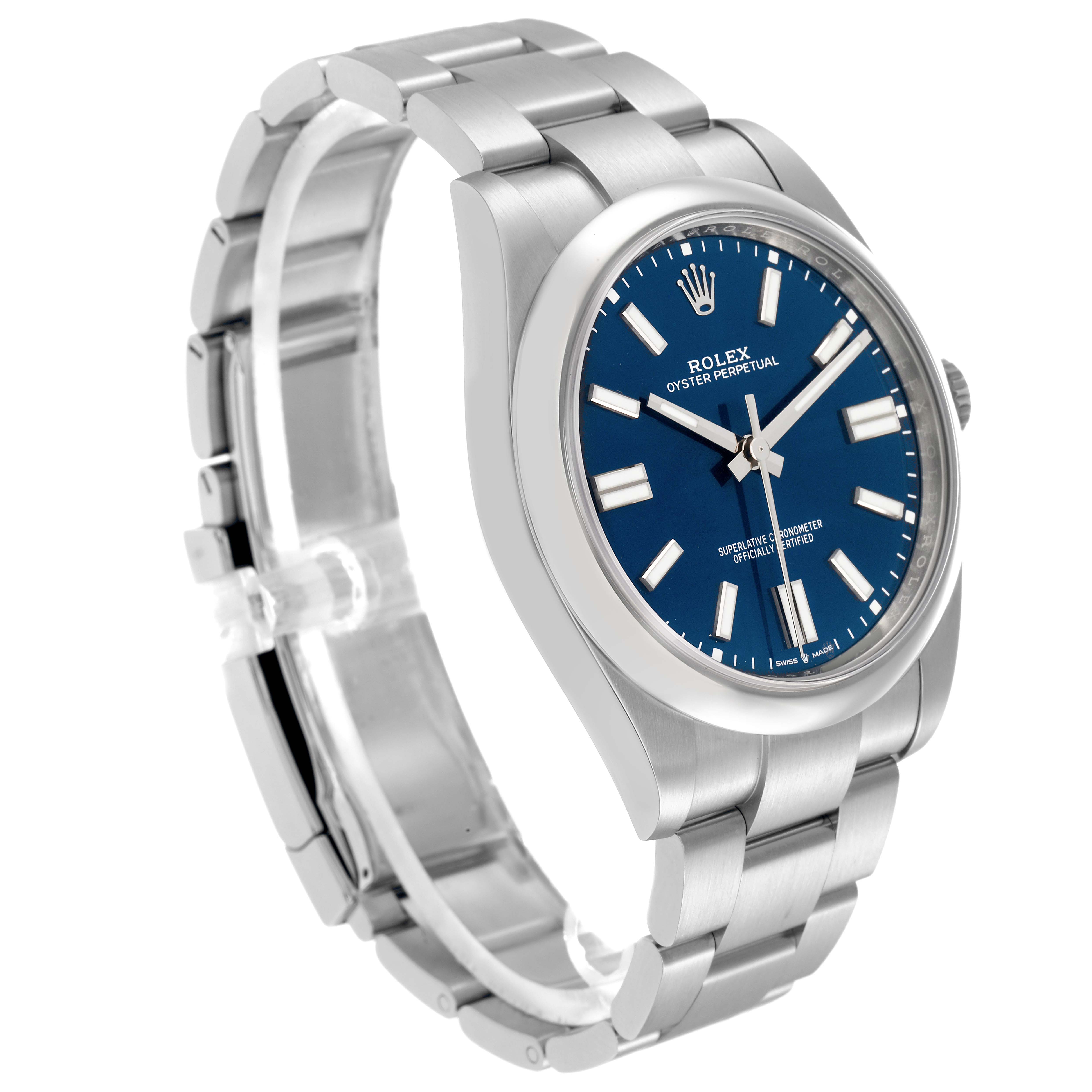 The Rolex Oyster Perpetual model 124300 is shown from a three-quarter angle, displaying its blue dial, hour markers, case, and metal bracelet.
