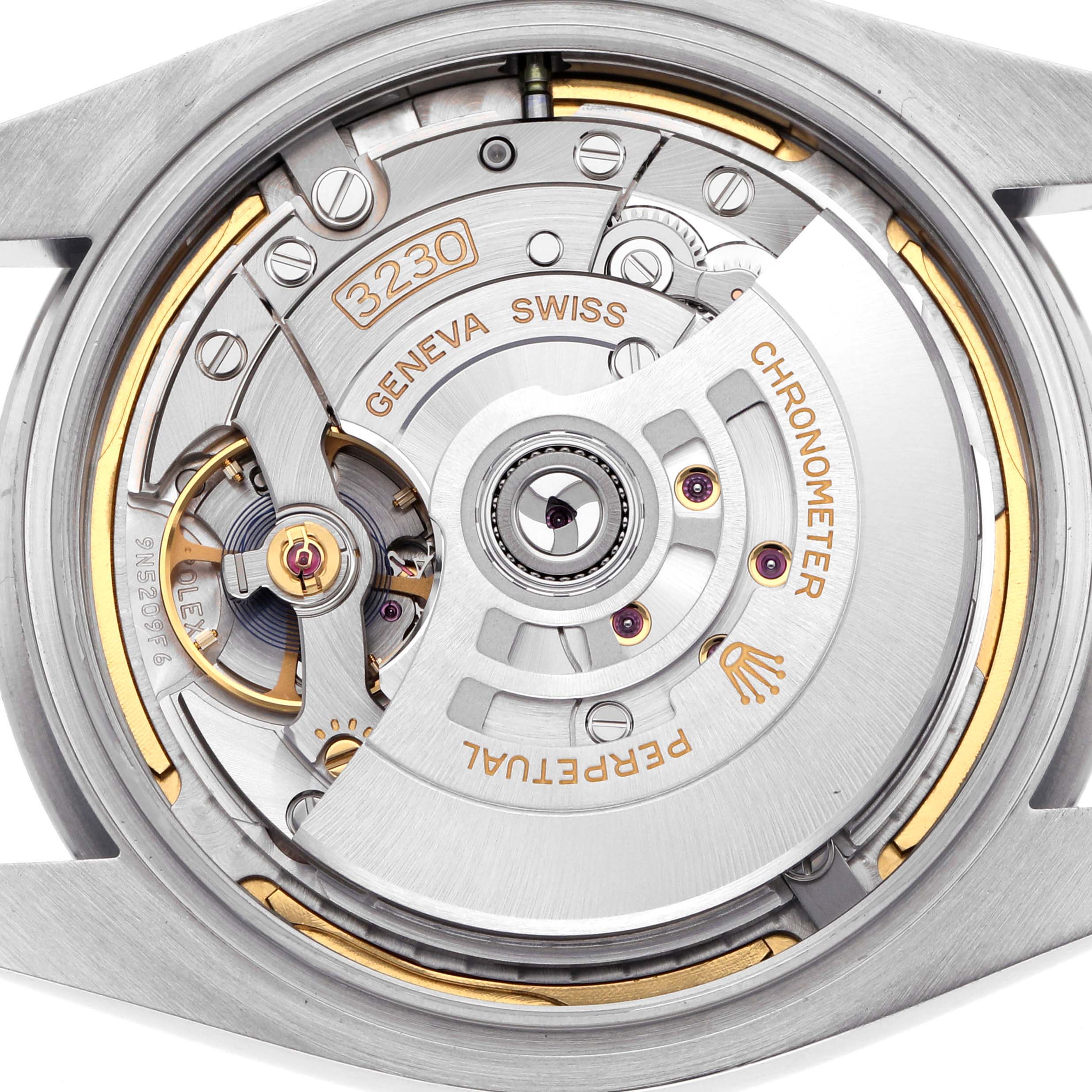 The image shows the movement and intricate mechanics of a Rolex Oyster Perpetual watch, model 124300, viewed from the back with visible rotor and gears.