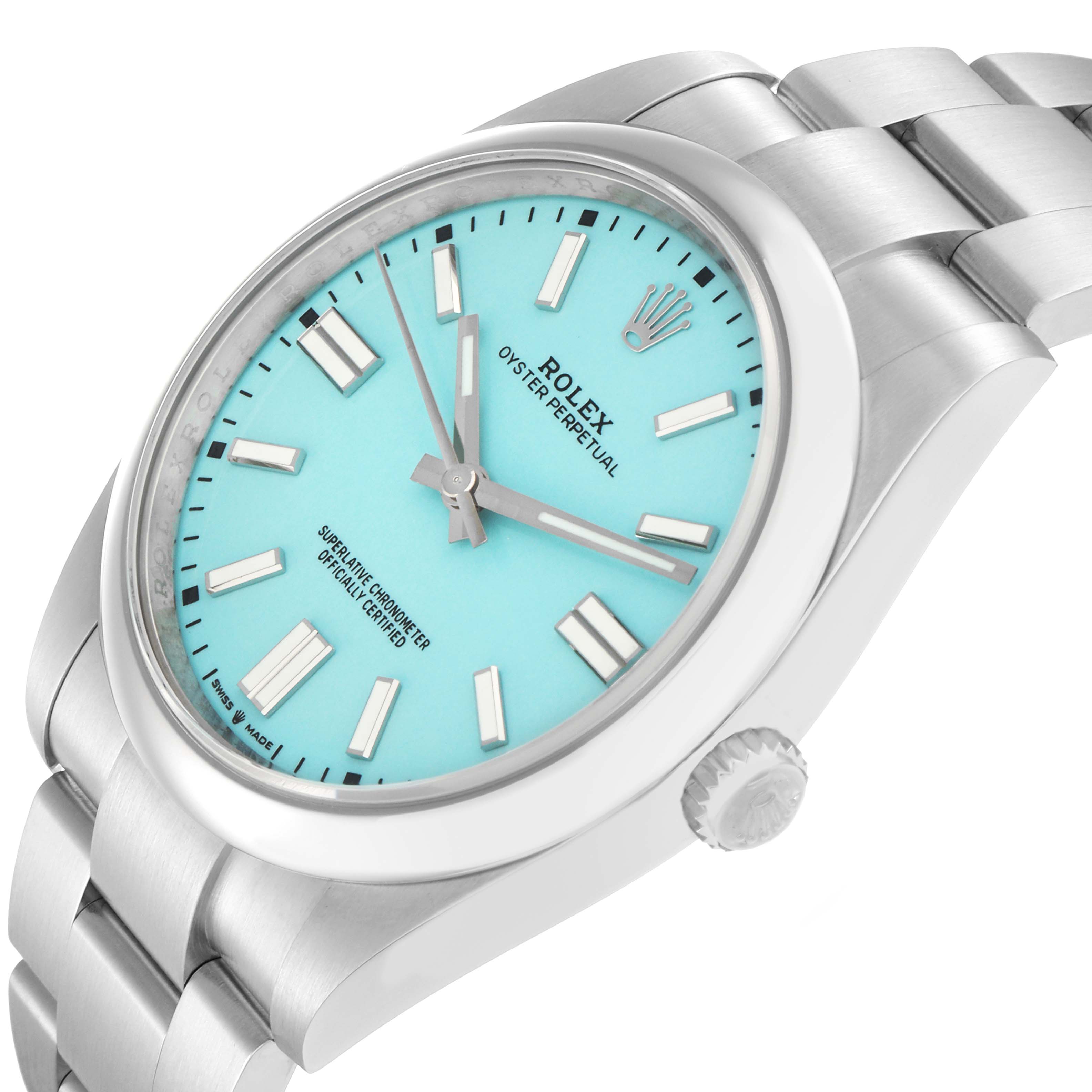 The Rolex Oyster Perpetual model 124300 is shown at a slight angle, displaying the face, crown, and a portion of the bracelet.