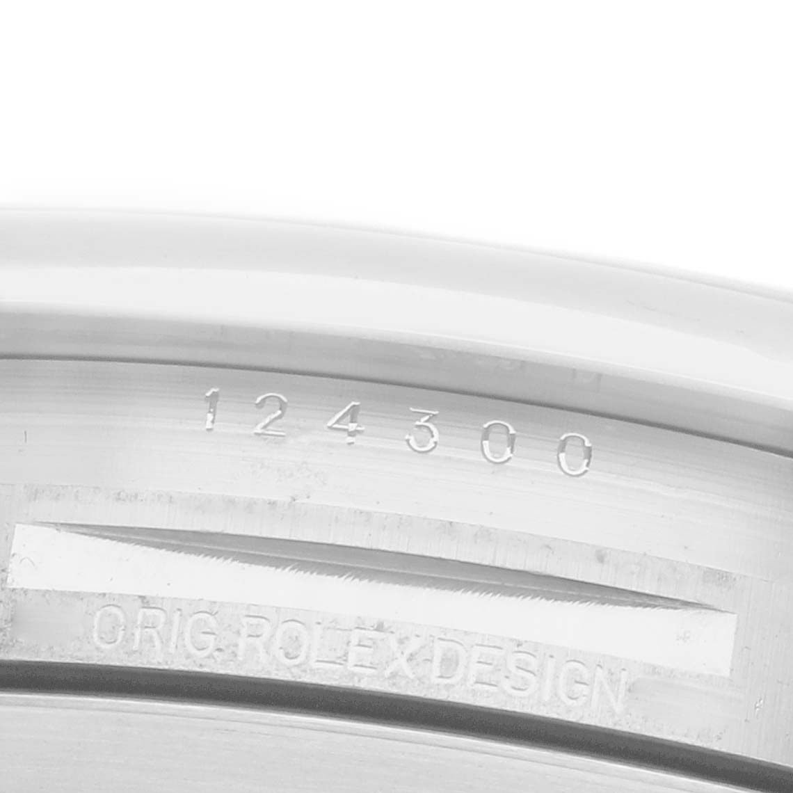 The image shows a close-up of the inner case edge of a Rolex Oyster Perpetual, model number 124300, displaying the engraved model number and "ORIG ROLEX DESIGN."
