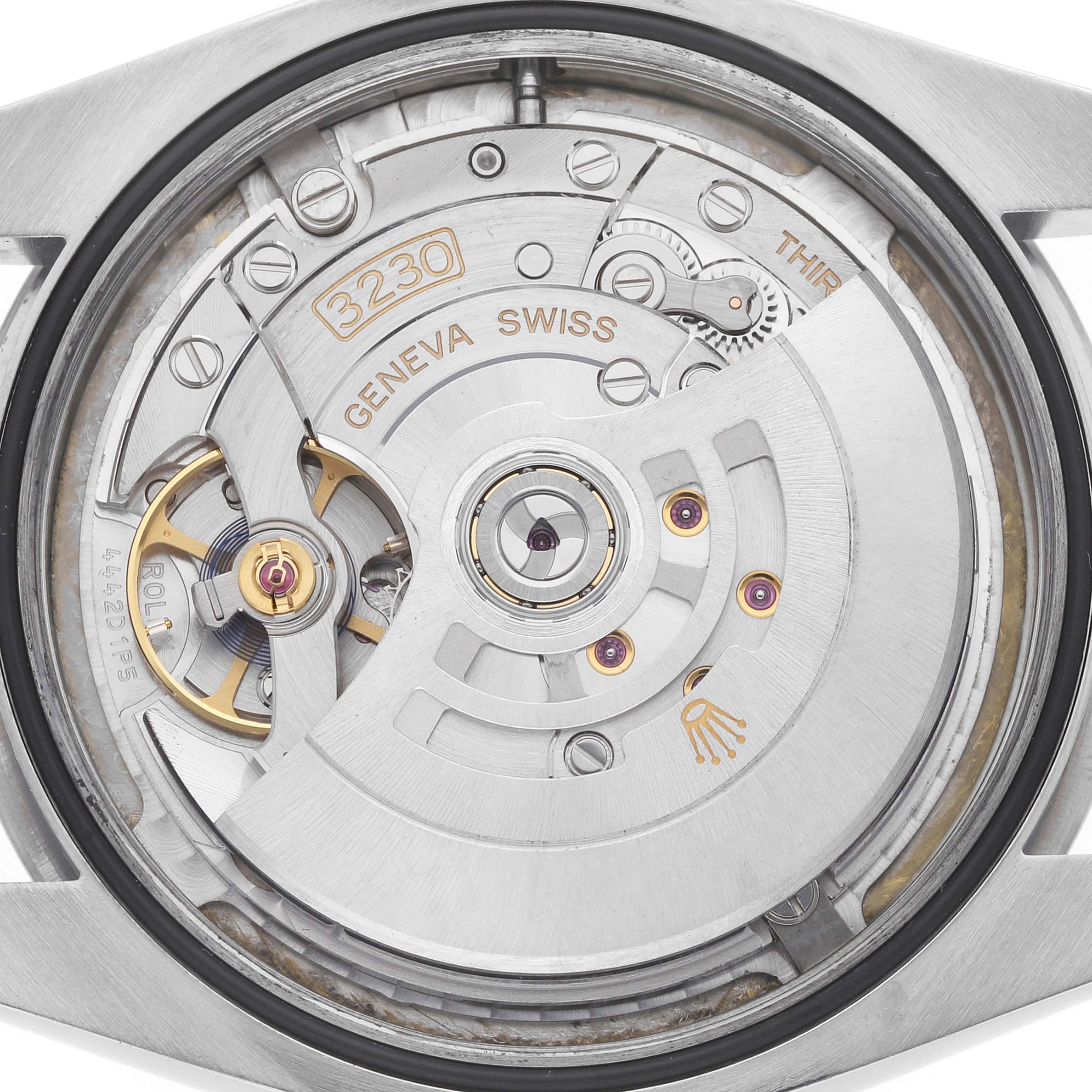 The image shows the movement of the Rolex Oyster Perpetual, model number 124300, viewed from the back, highlighting the intricate mechanics and rotor.
