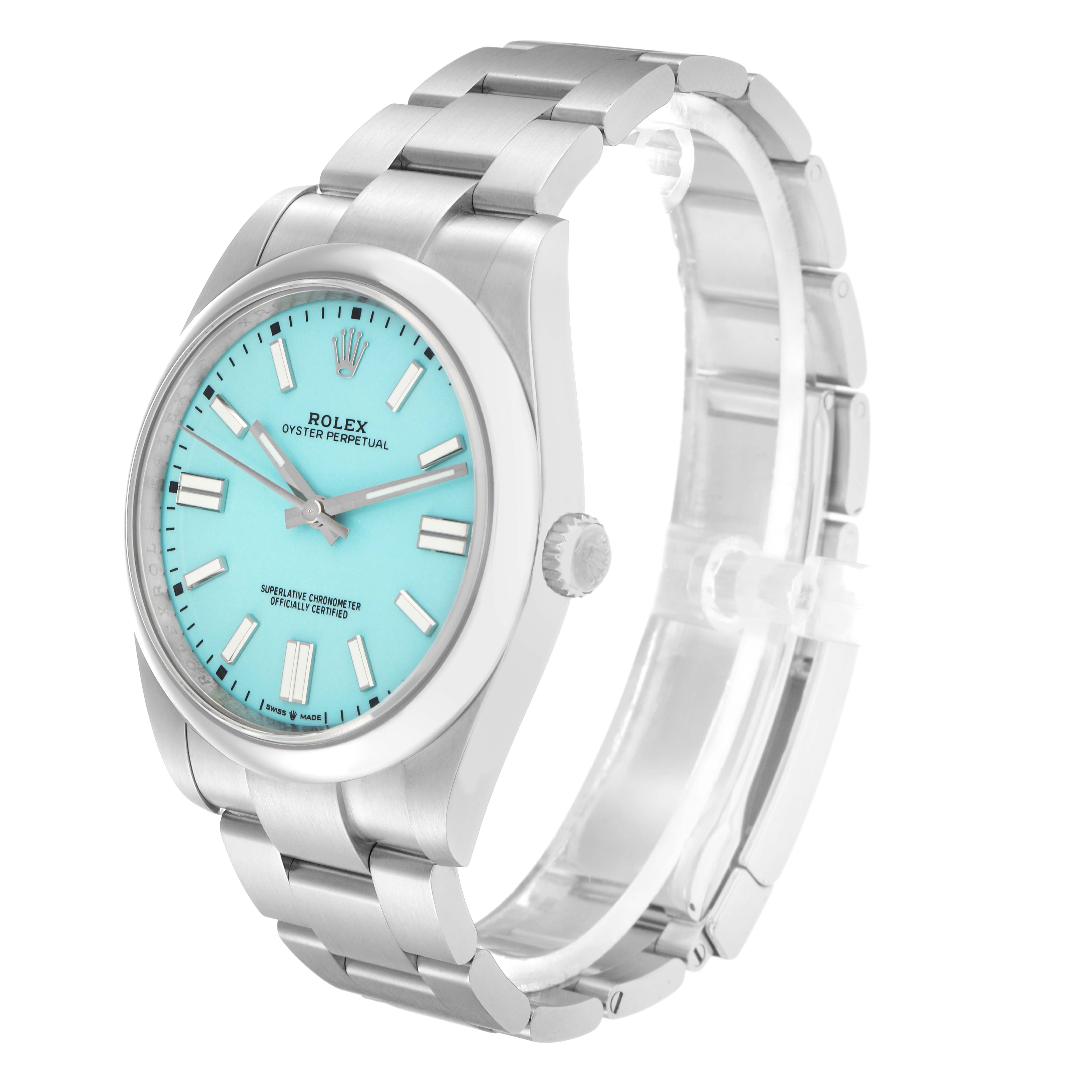 The Rolex Oyster Perpetual model 124300 is shown at a slight angle, displaying its turquoise dial, stainless steel case, bezel, and bracelet.