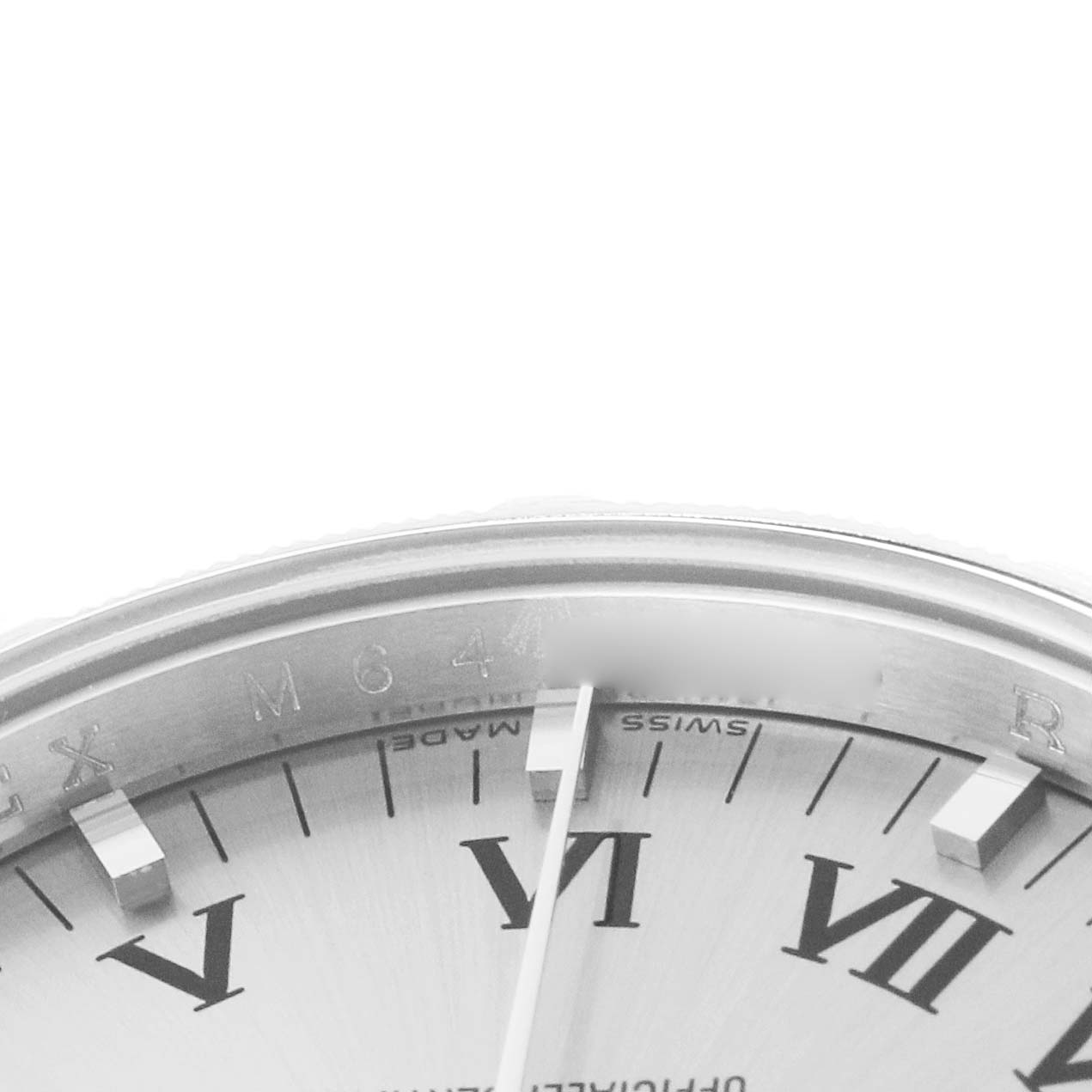 The image shows a close-up of the Rolex Air-King, model 114210, focusing on the upper part of the dial with visible indices and part of the bezel.