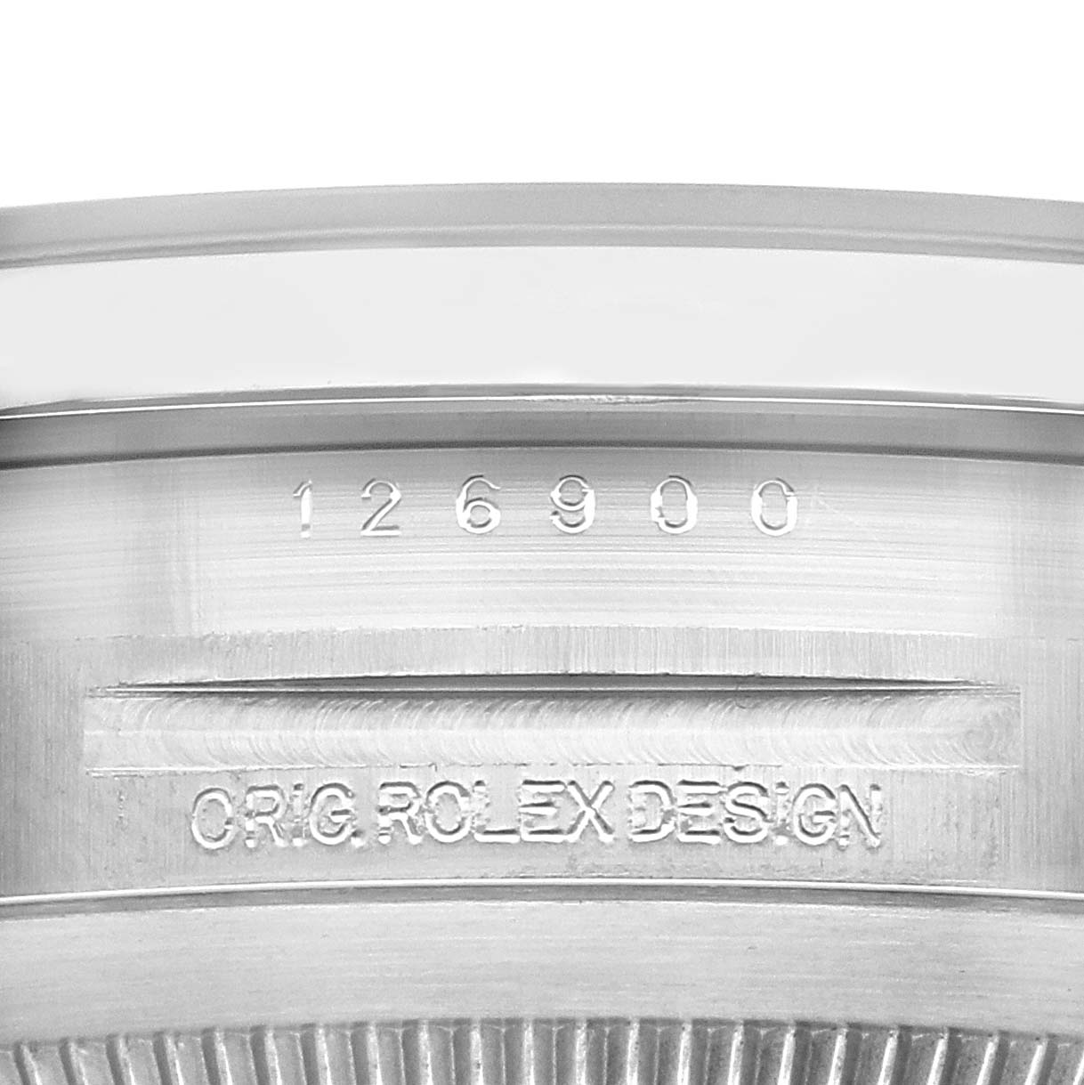 The image shows a close-up of the case side of a Rolex Air-King model number 126900, highlighting the engraved model number and "ORIG. ROLEX DESIGN" text.