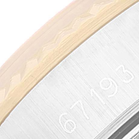 This close-up image shows part of the bezel and the engraved model number "67193" on the Rolex Oyster Perpetual 67193 Women's Steel and Gold (two tone) Champagne Dial 67193 Women's Steel and Gold (two tone) Champagne Dial watch.