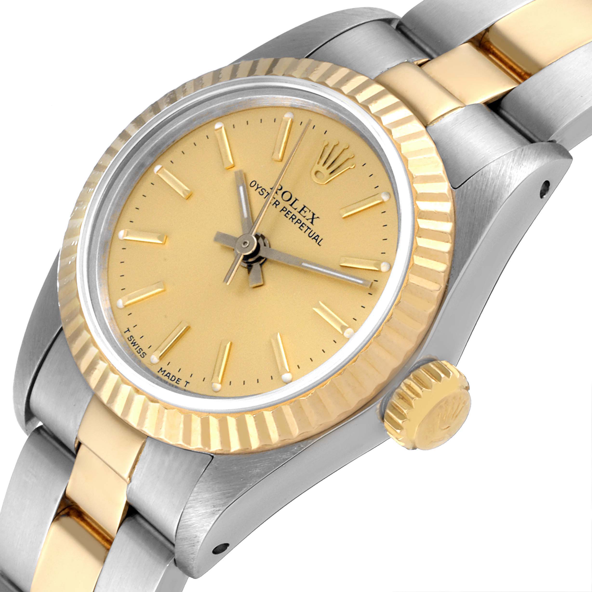 The Rolex Oyster Perpetual 67193 Women's Steel and Gold (two tone) Champagne Dial 67193 Women's Steel and Gold (two tone) Champagne Dial watch is shown from an angled view, highlighting its gold dial and two-tone metal bracelet.