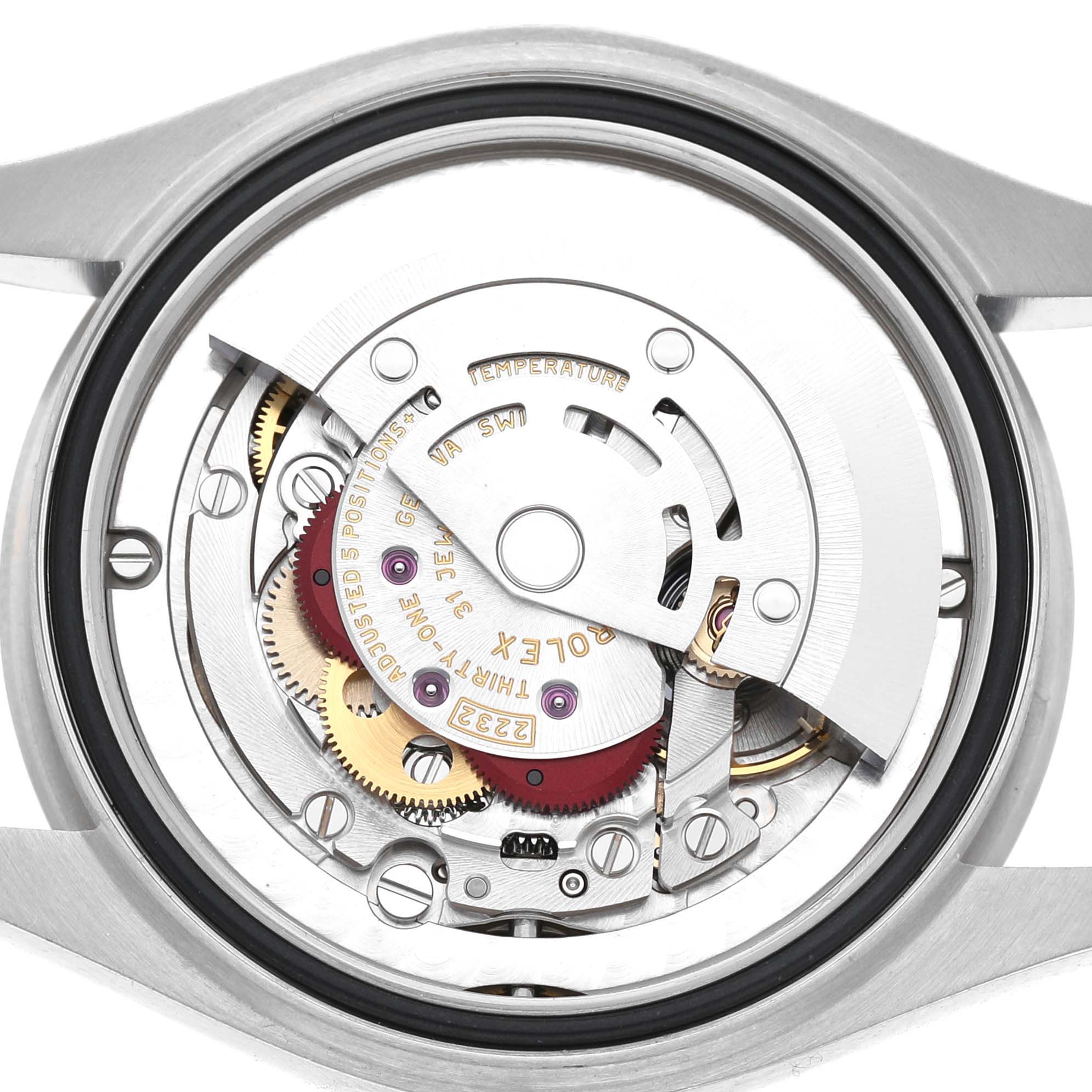 The image shows the movement of a Rolex Oyster Perpetual 277200 Women's Stainless Steel Green Dial watch from a back angle, highlighting gears and components.