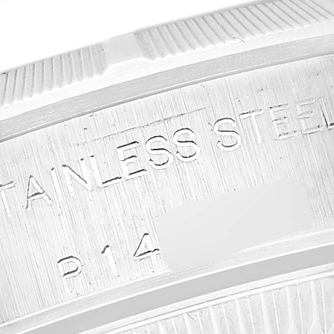 The image shows a close-up of the edge of a Rolex Oyster Perpetual 76030 Women's Stainless Steel White Dial 76030 Women's Stainless Steel White Dial watch case, highlighting the "STAINLESS STEEL" engraving.